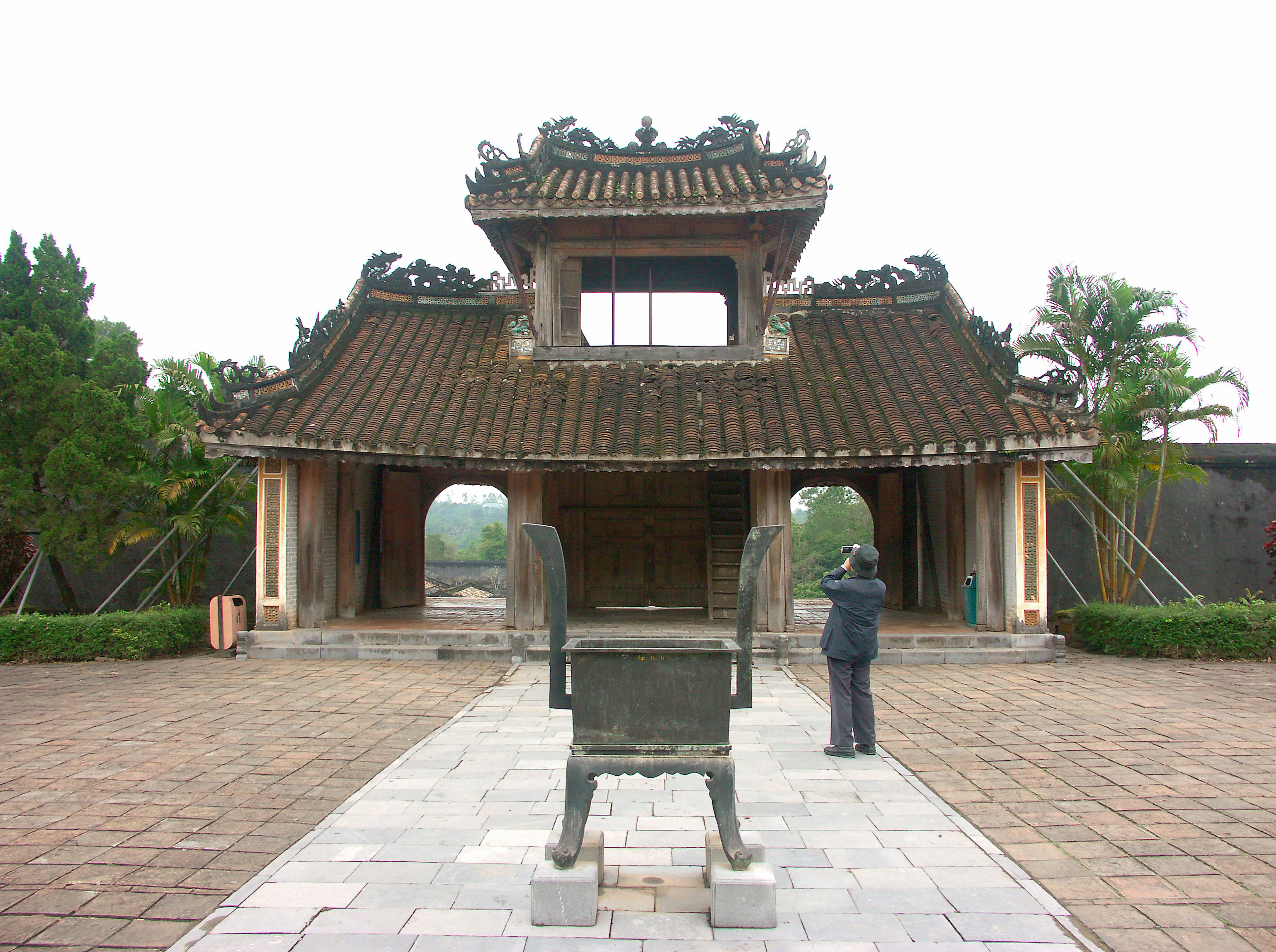 Ancient building with a bronze altar in the foreground