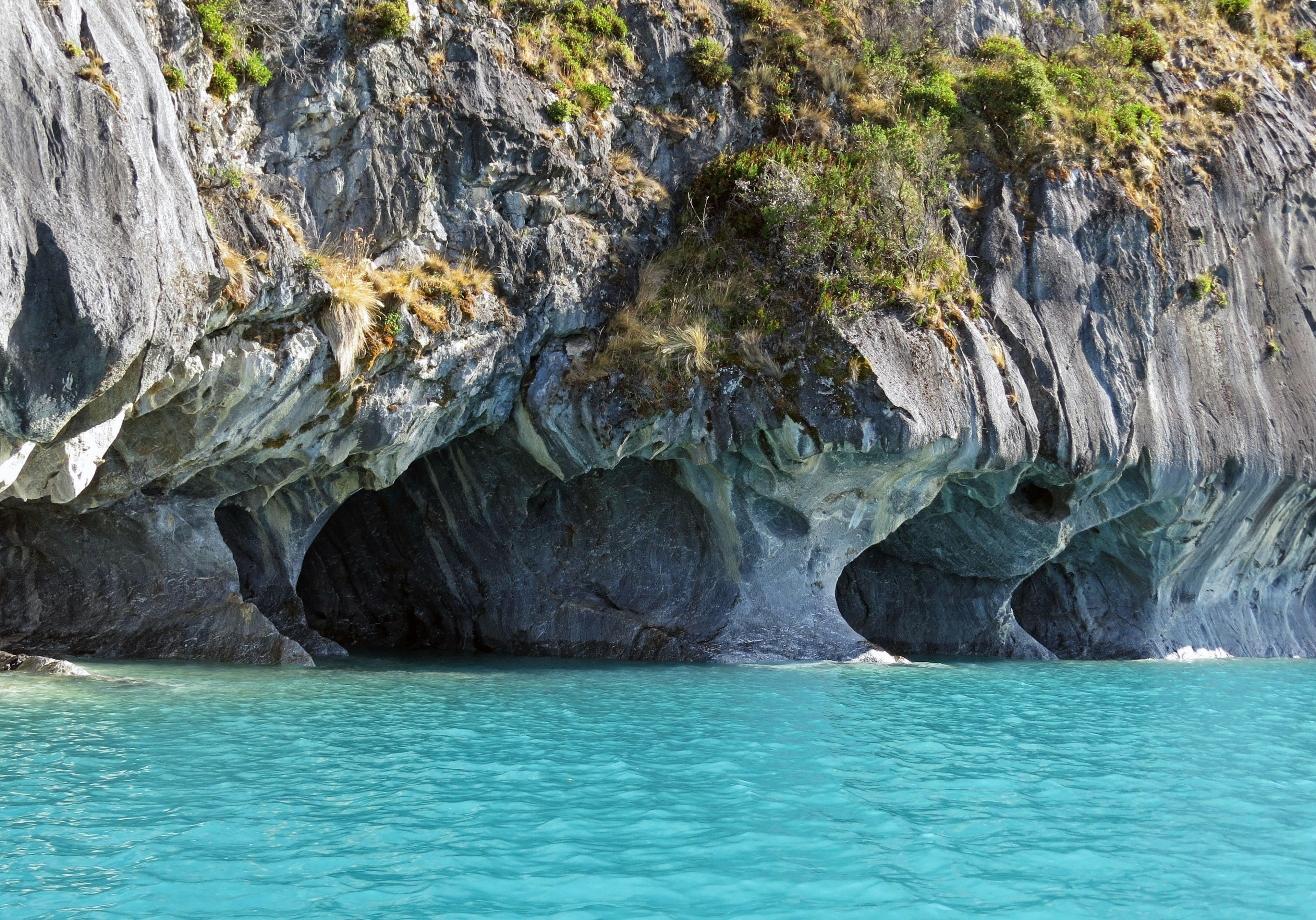 Beautiful landscape featuring blue water and rocky caves