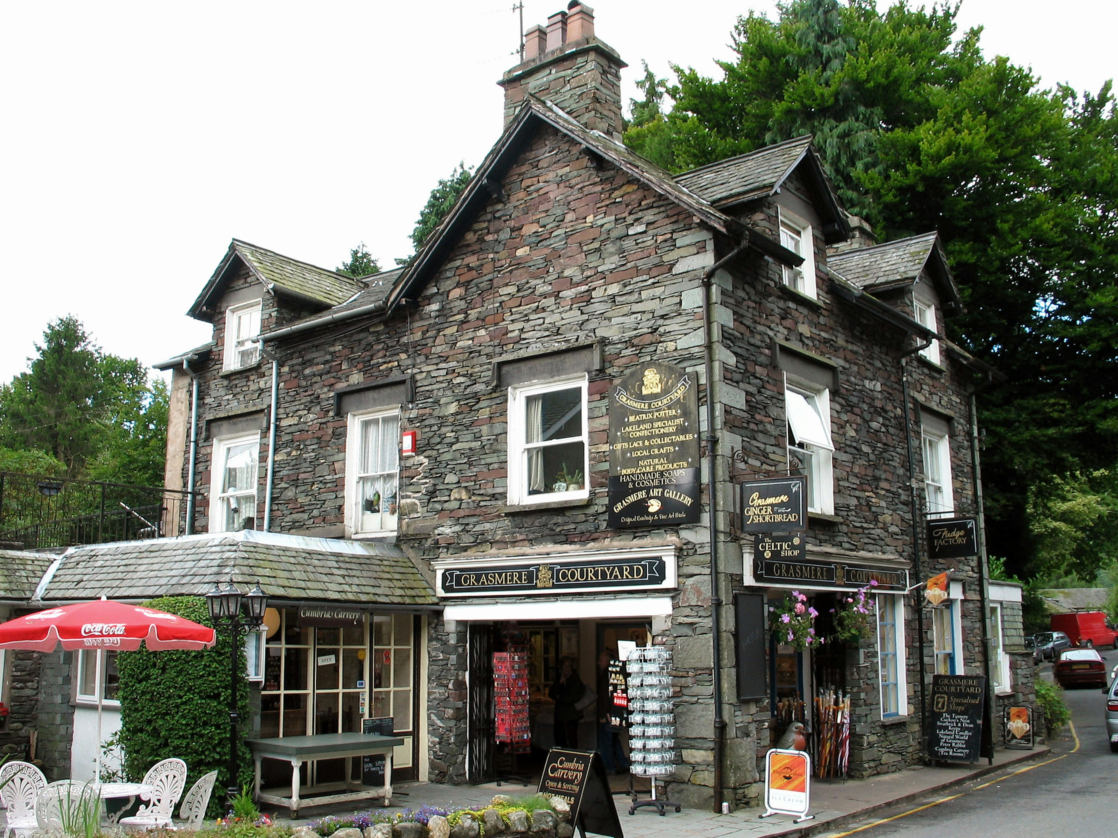 Stone building exterior with a café and shops