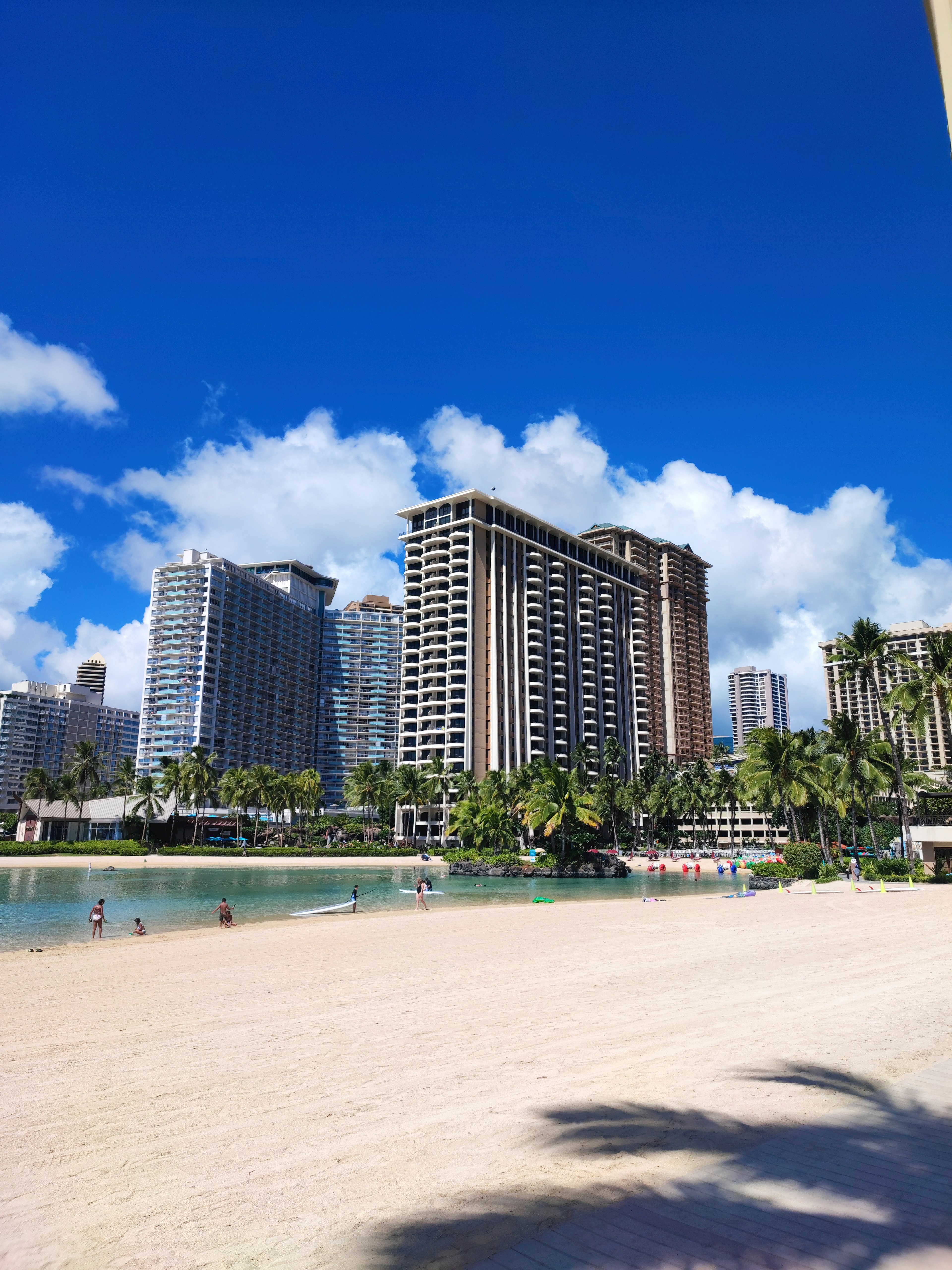 Beach view with high-rise buildings under a clear blue sky