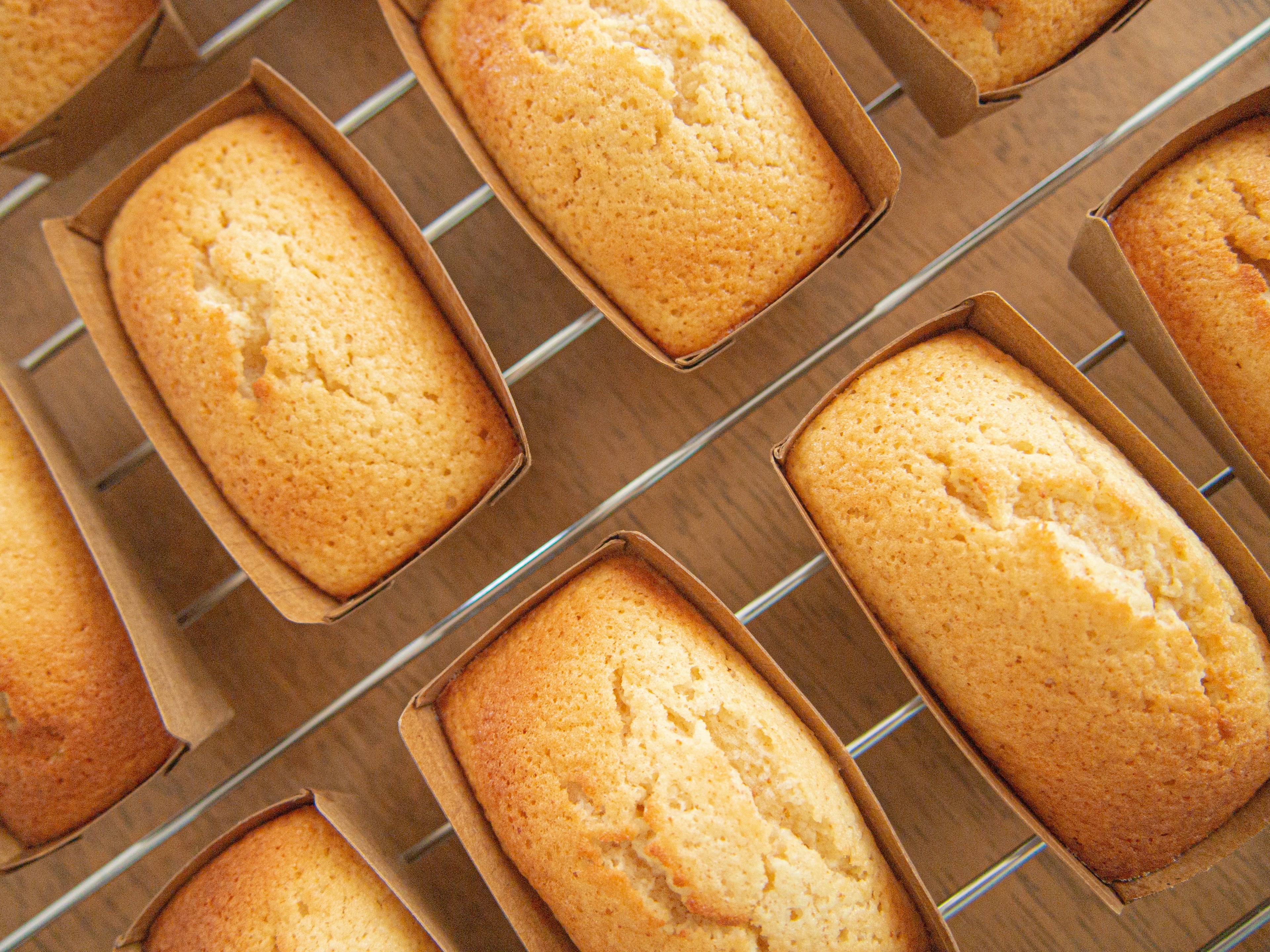 Freshly baked pound cakes arranged on a cooling rack