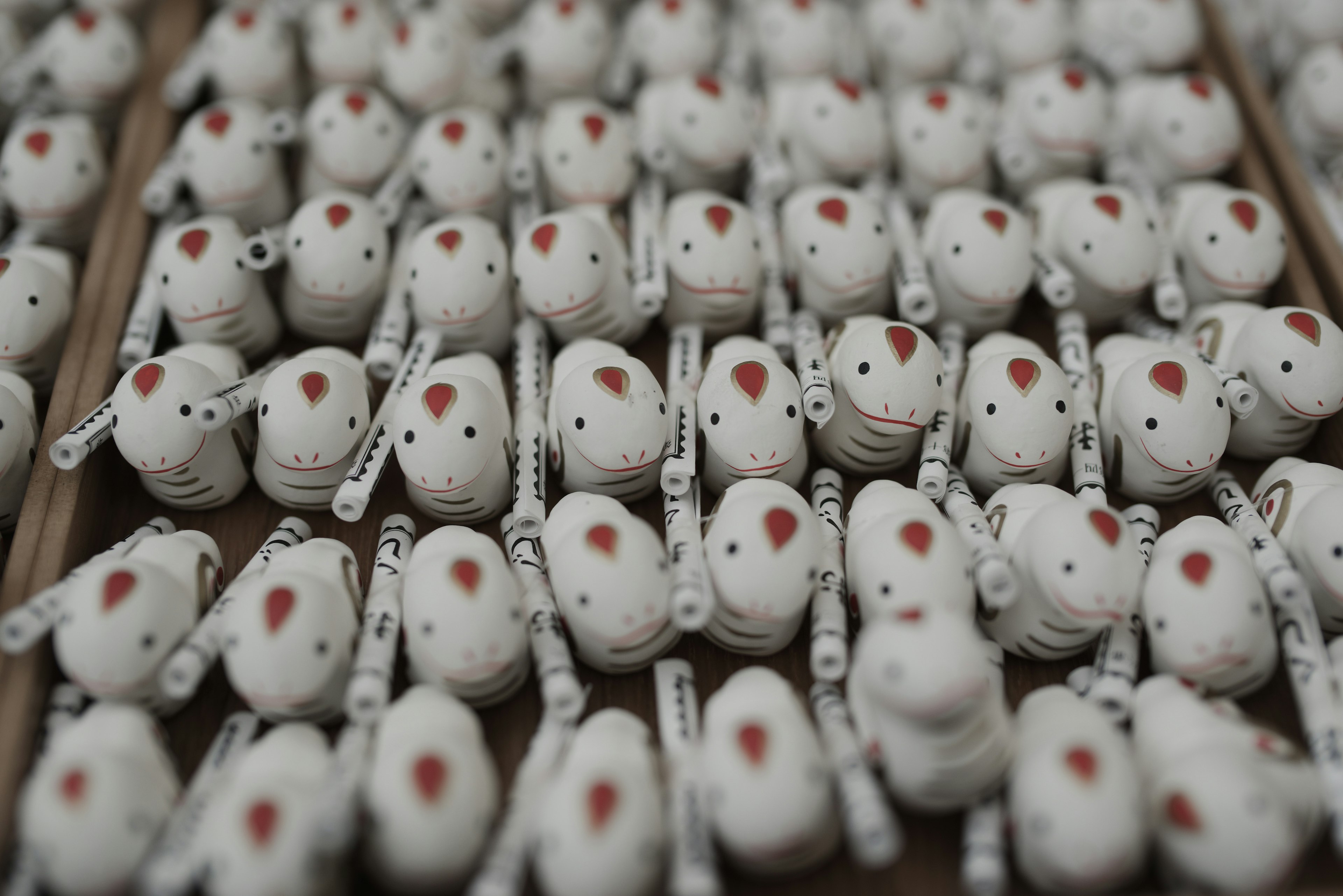 Small white animal figurines arranged neatly in rows