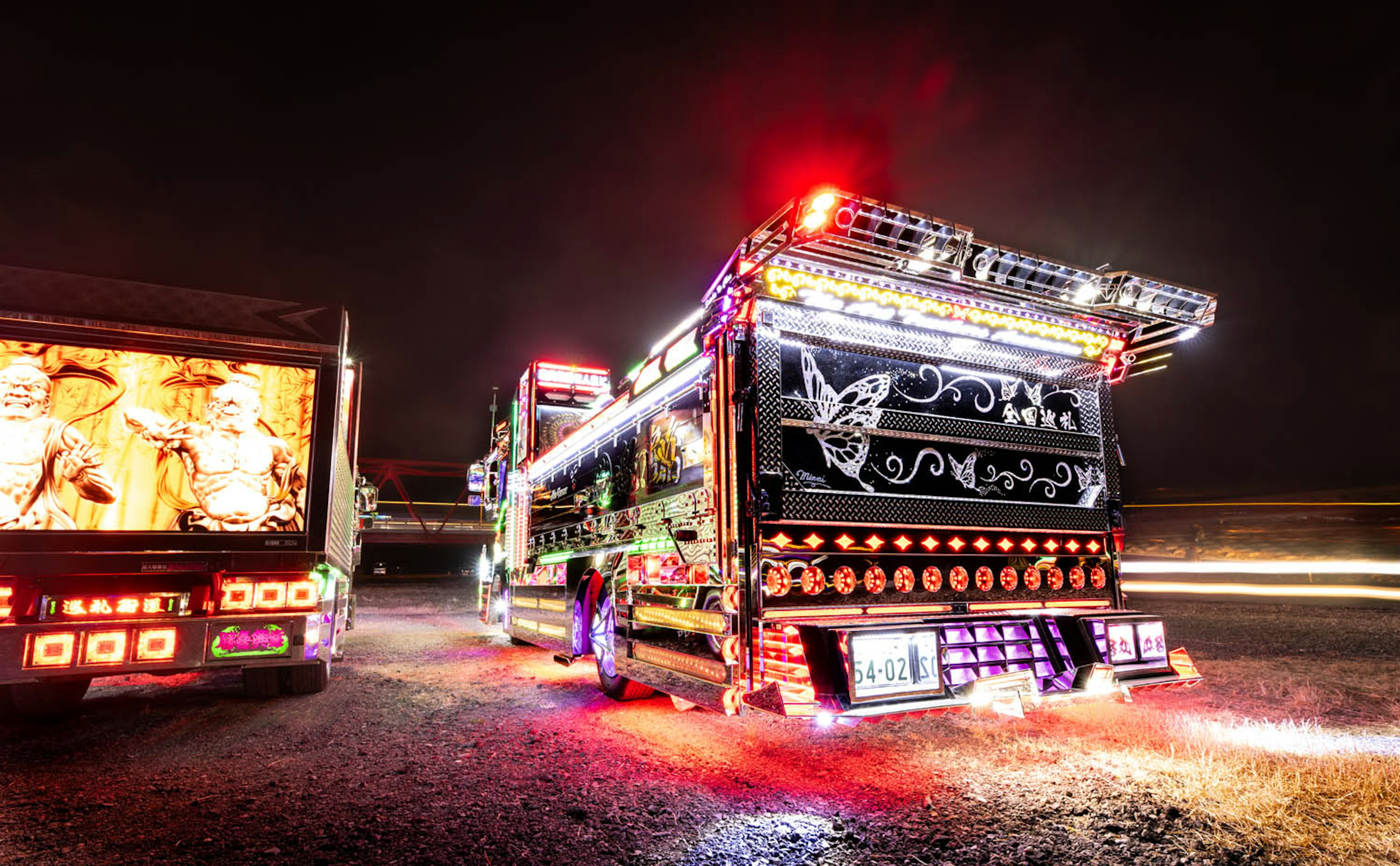 Rear view of a decorated truck glowing at night