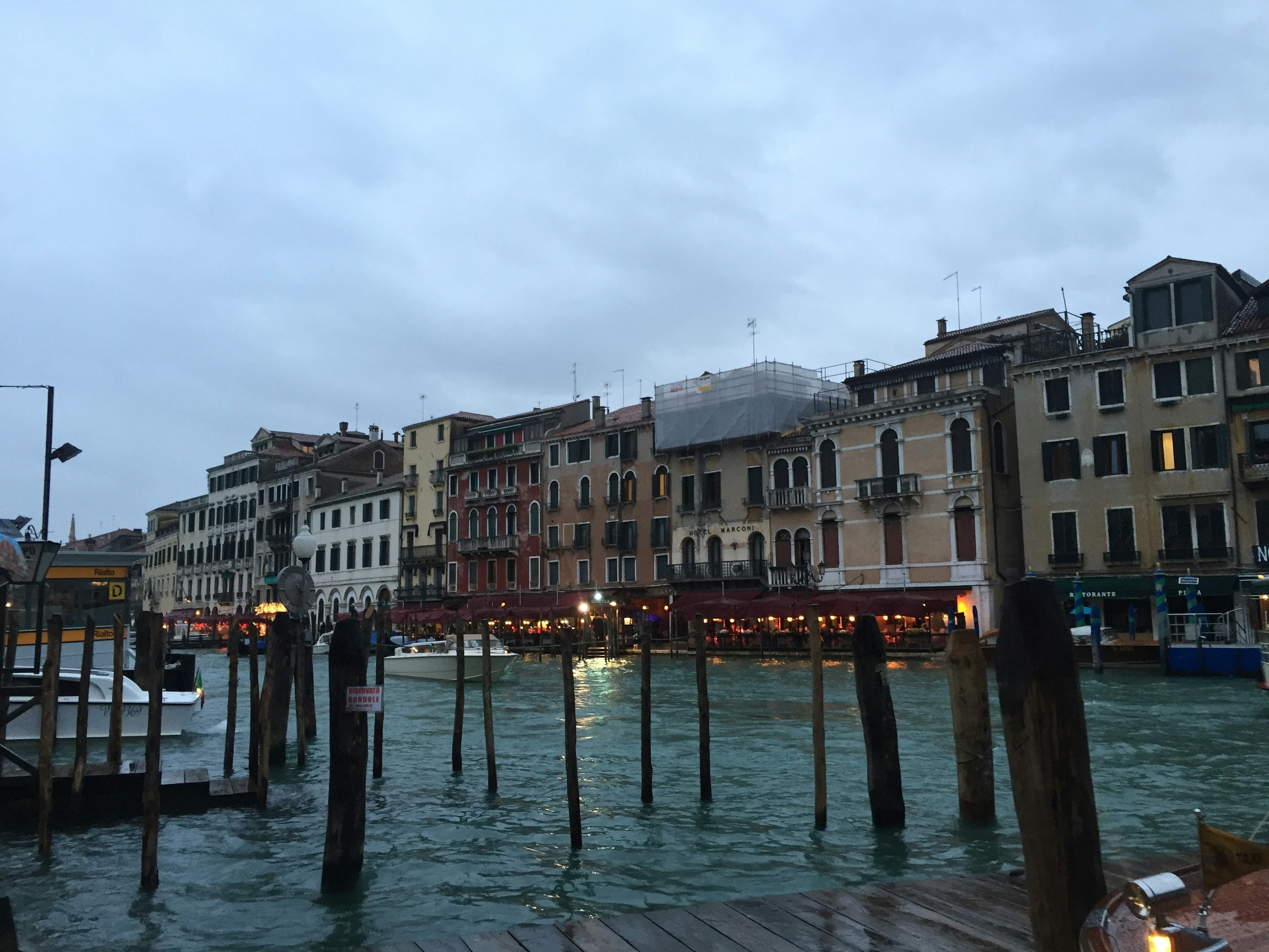 Venetian canal view featuring buildings and wooden posts