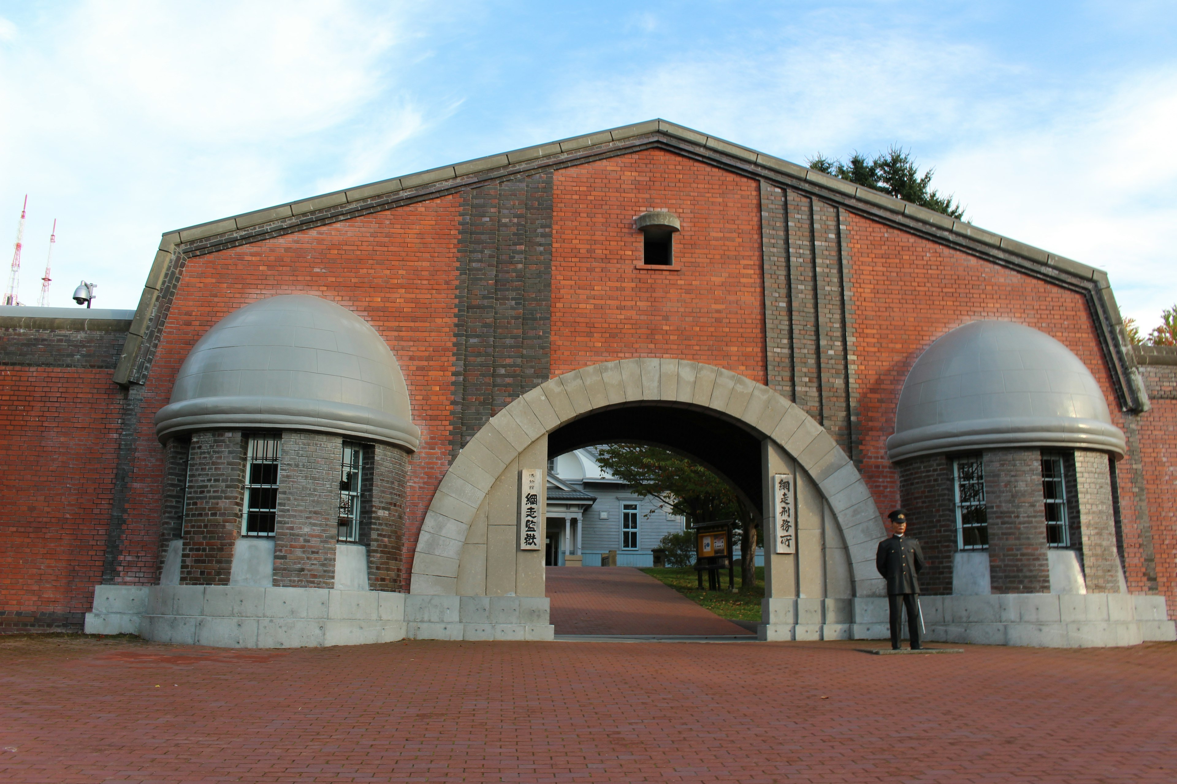 Historisches Gebäude mit einem Bogen aus Ziegeln und kuppelförmigen Fenstern