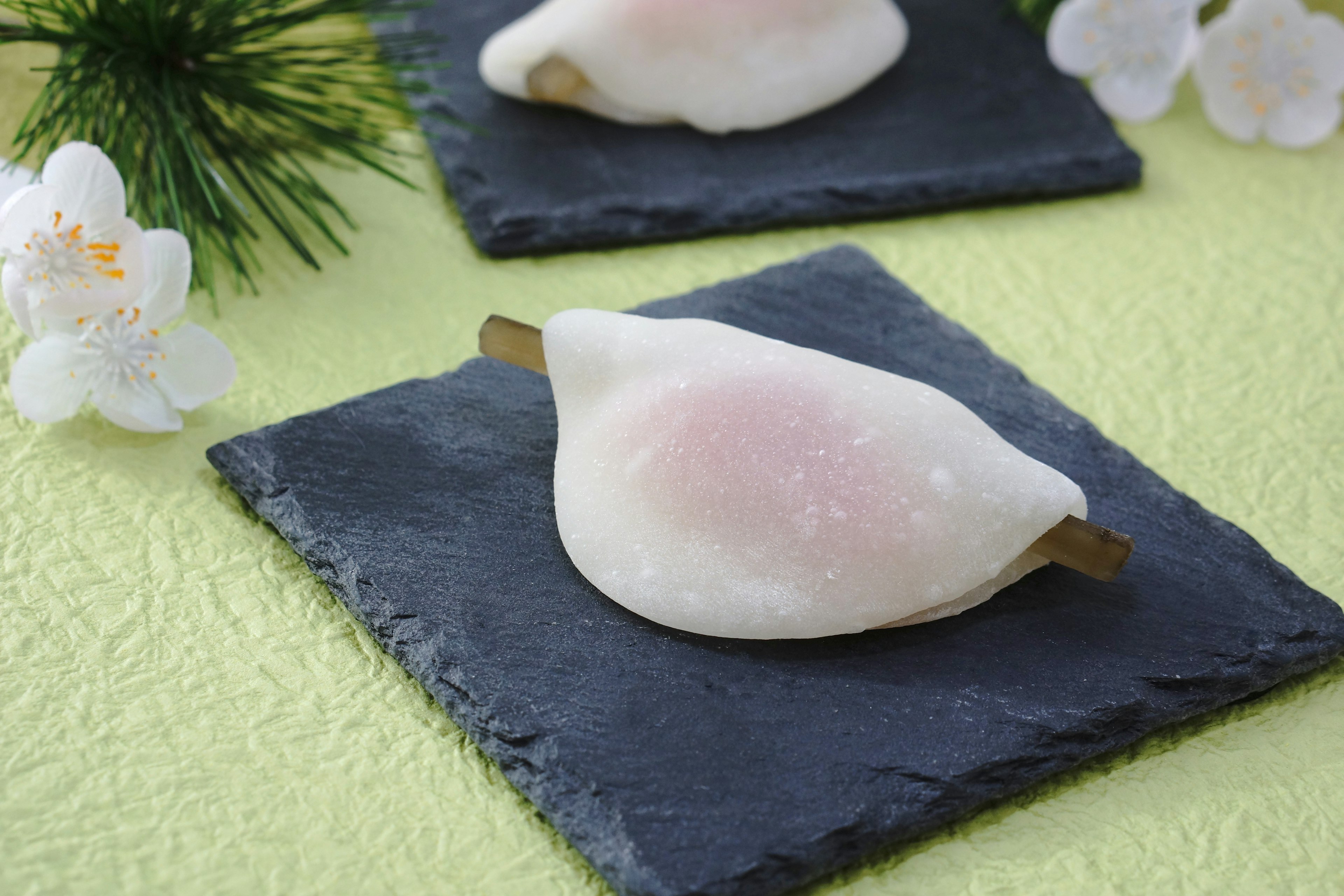 Japanese sweets displayed on black slate plates