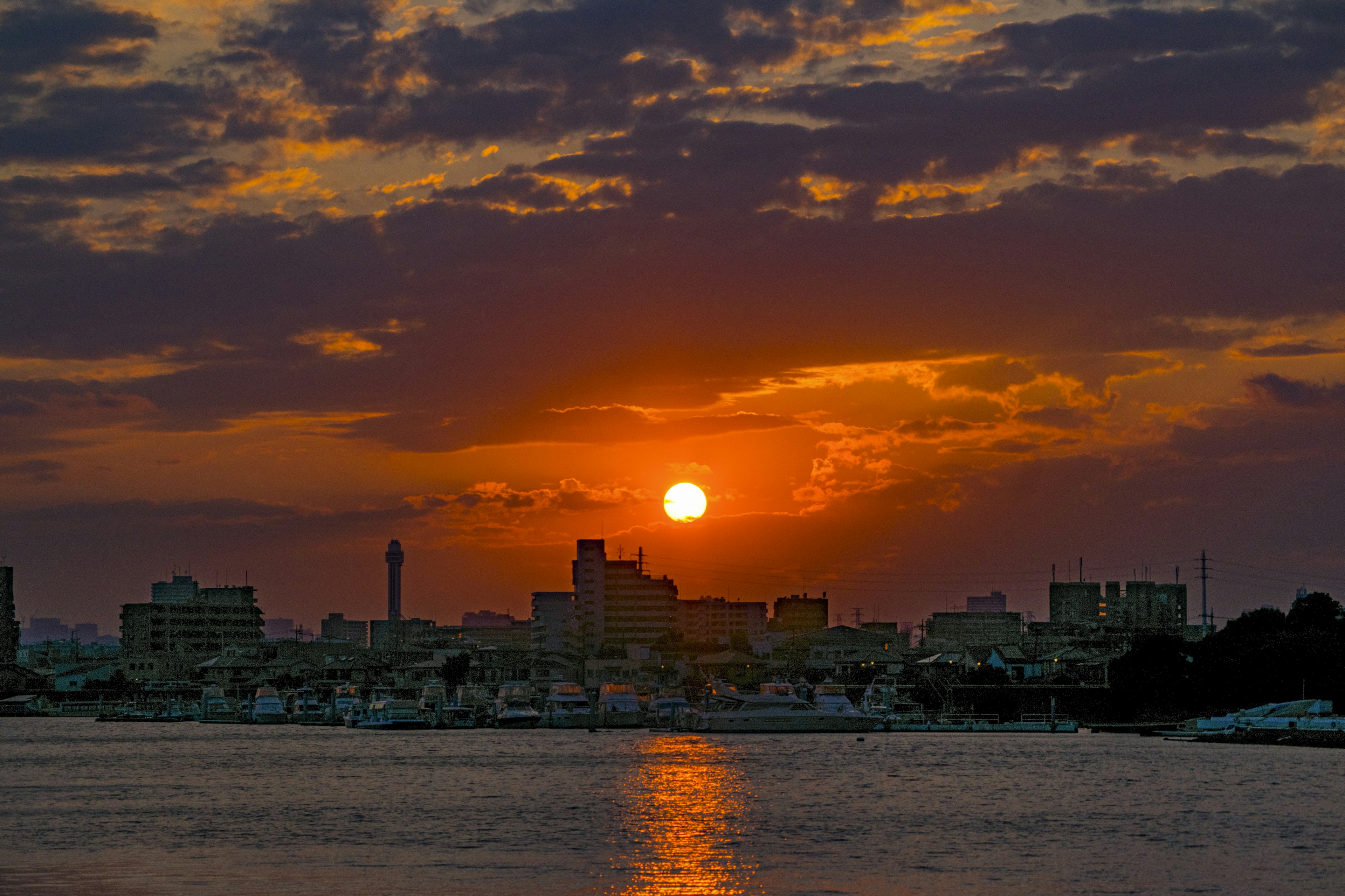 Cityscape at sunset with reflections on the water