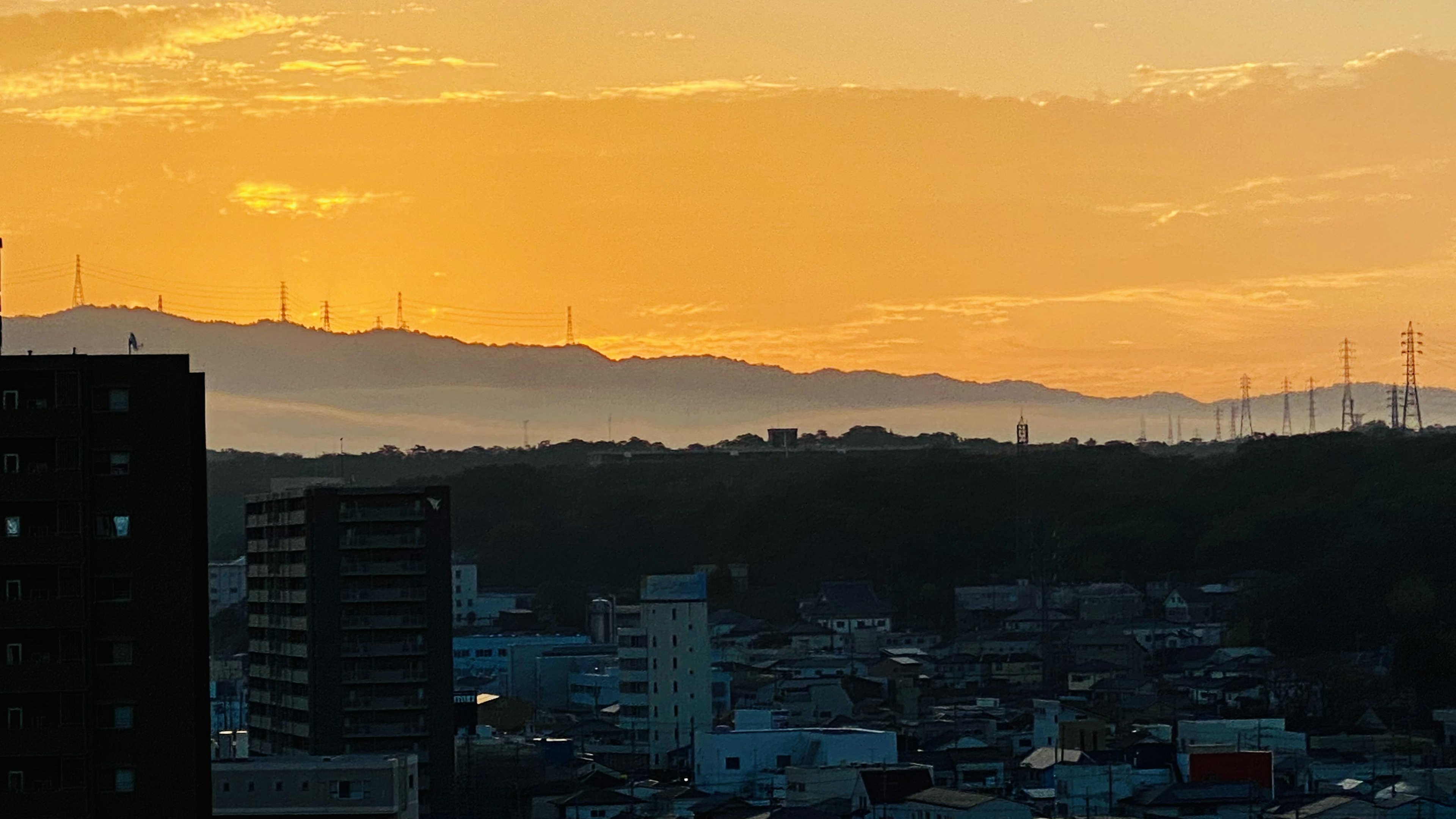 日落时的城市天际线和背景中的山脉