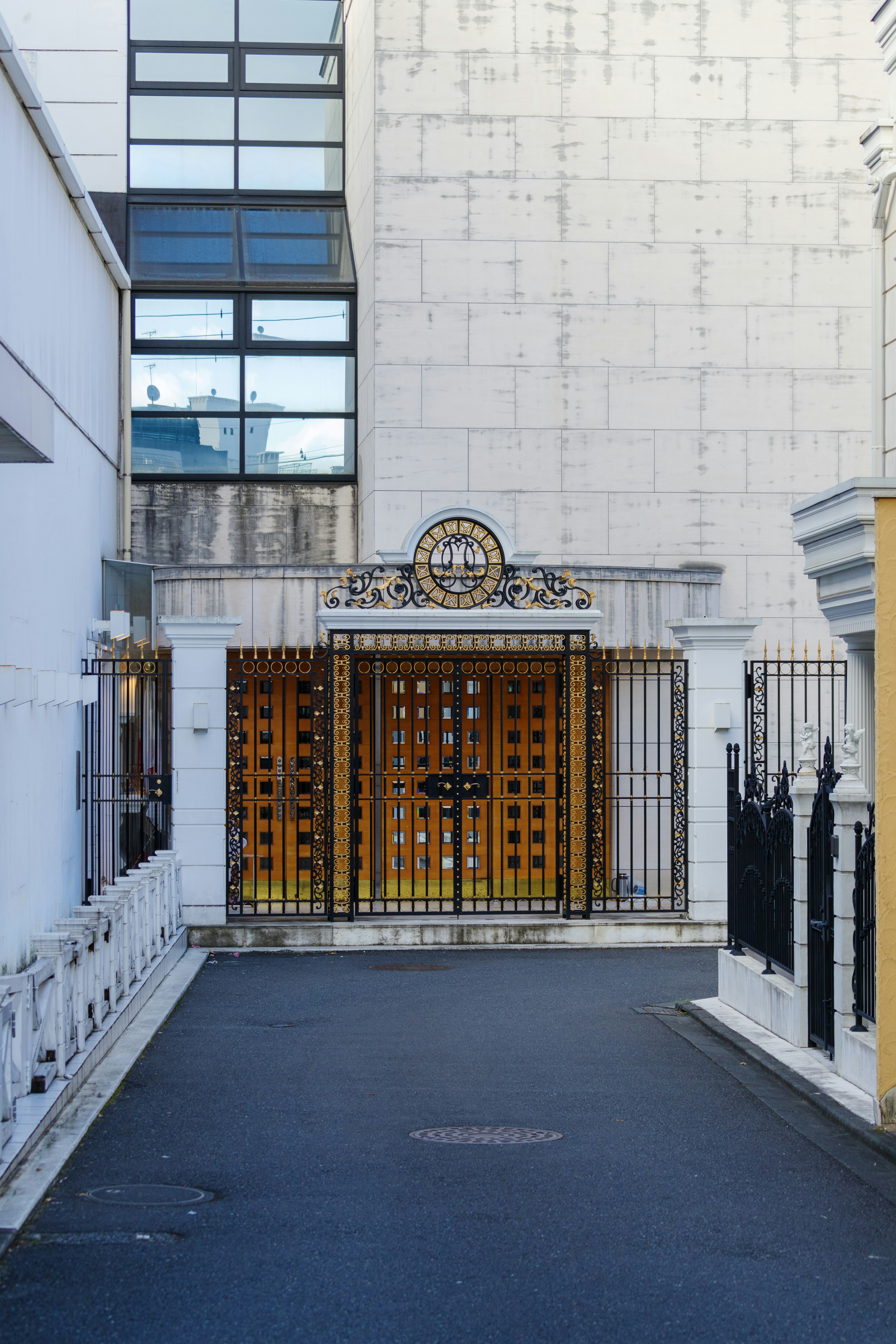 A modern building with a classic designed entrance and decorative gate