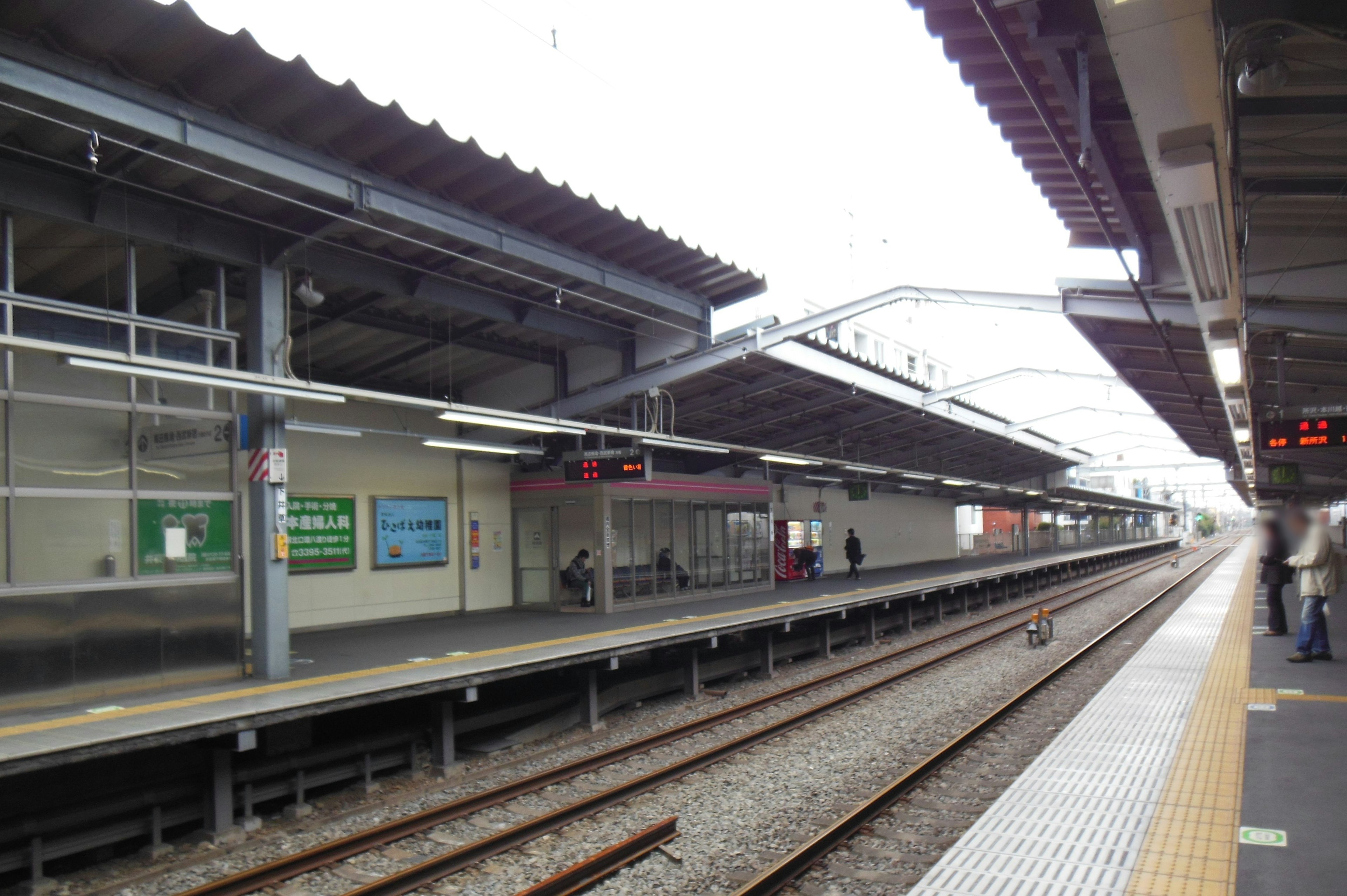 View of a train station platform with tracks