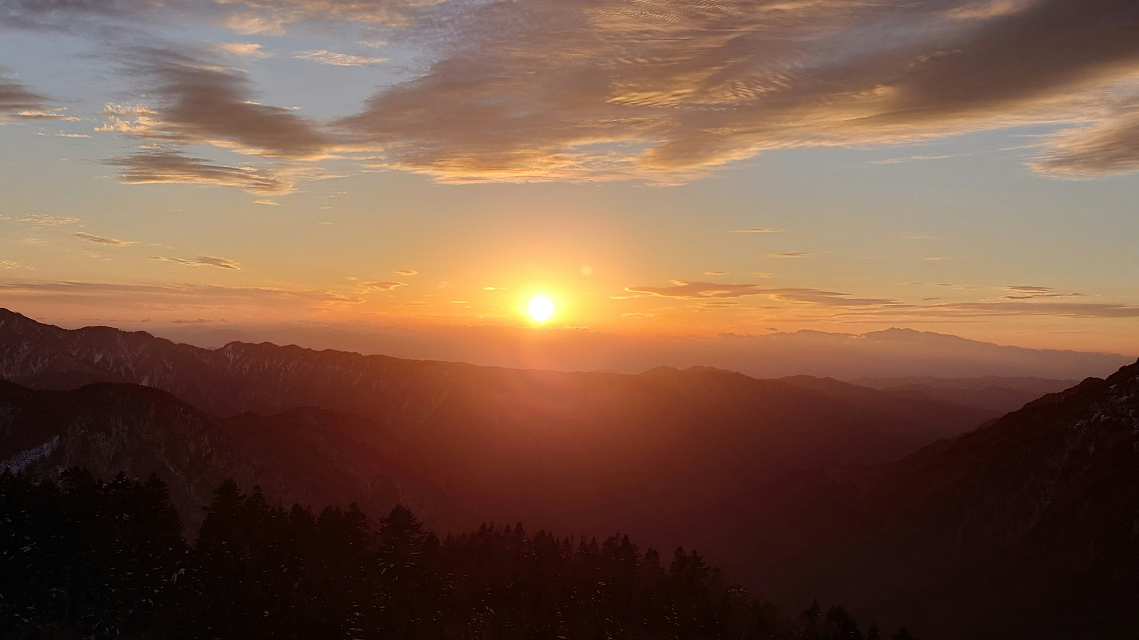 Bellissimo tramonto con montagne in primo piano