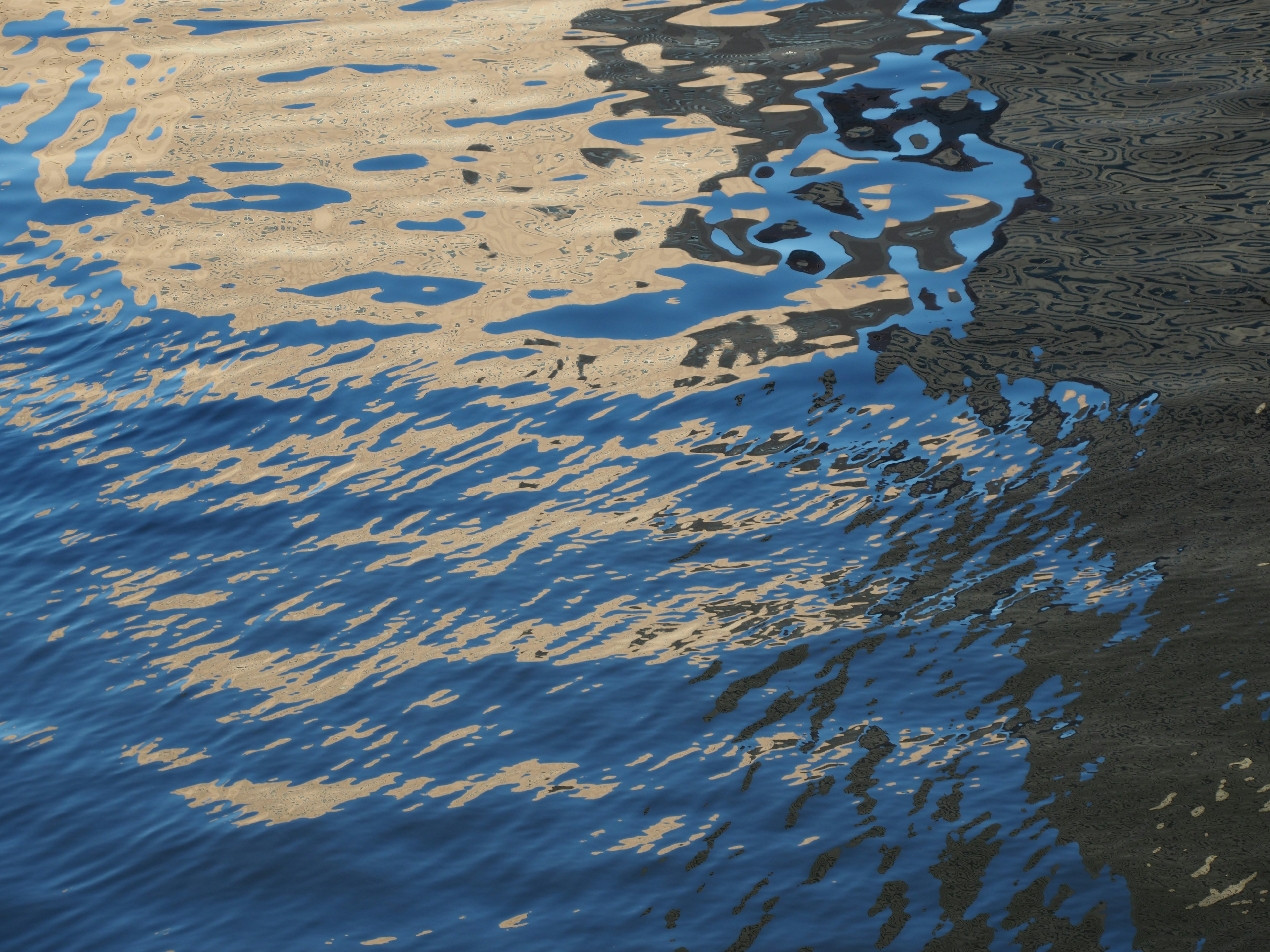 Rippling blue water with reflections