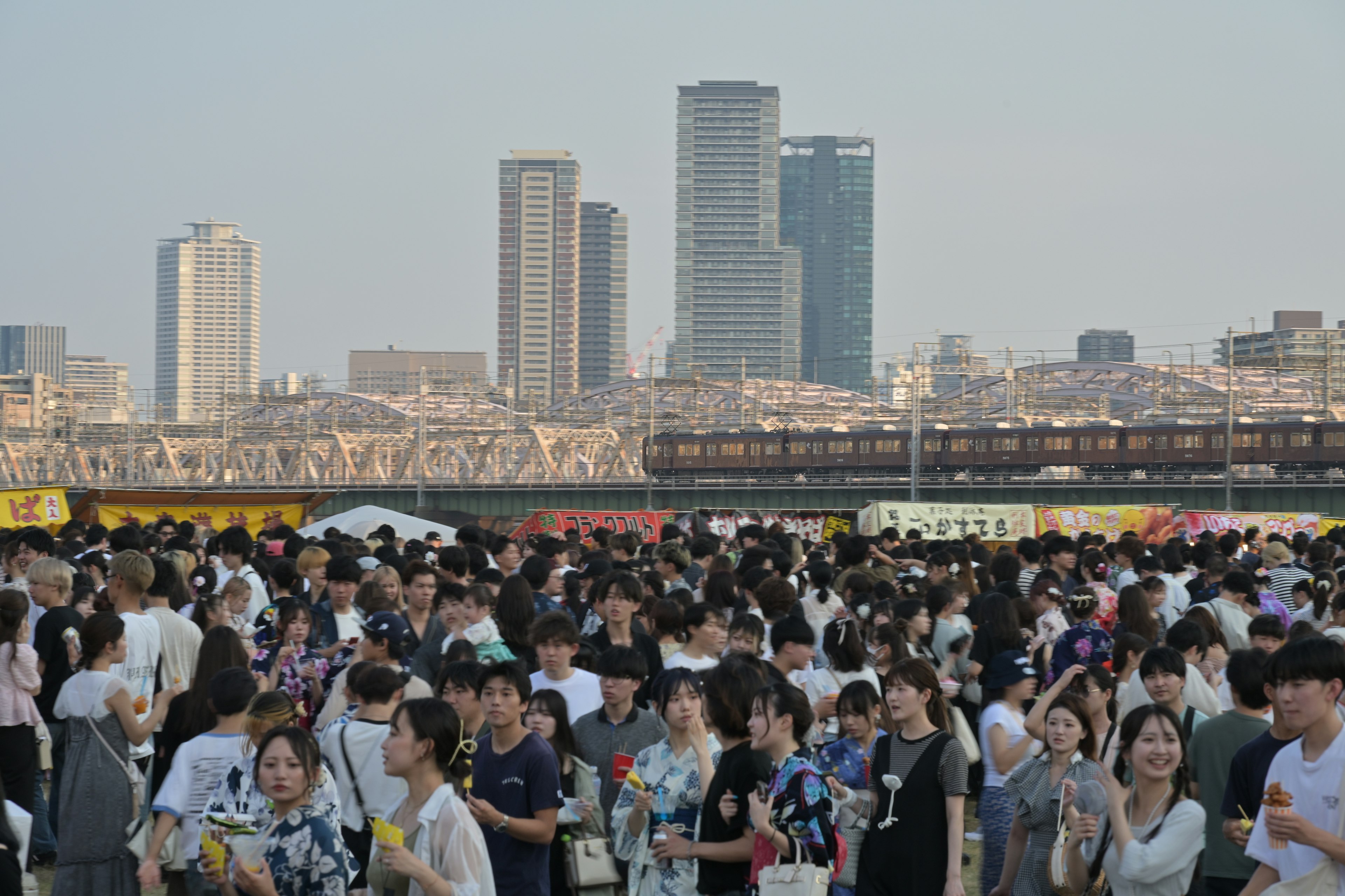 Crowd of people in a cityscape with tall buildings in the background