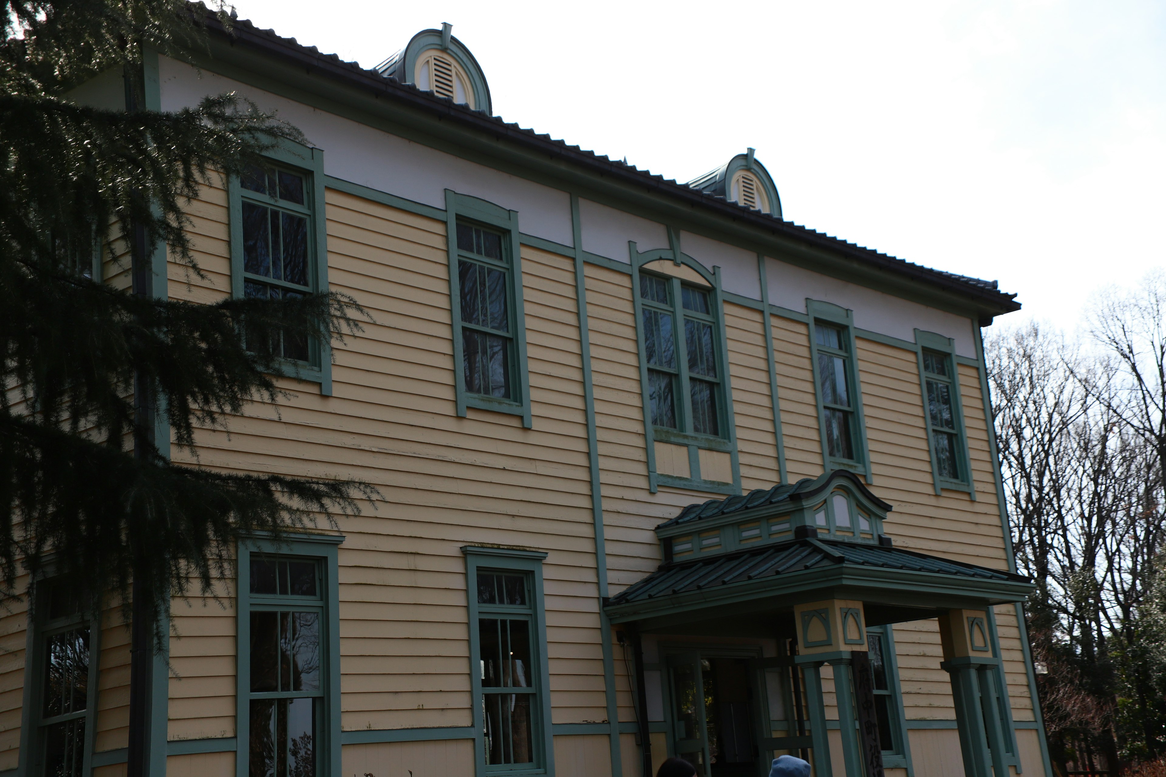 Bâtiment historique avec façade jaune et encadrements de fenêtres bleus