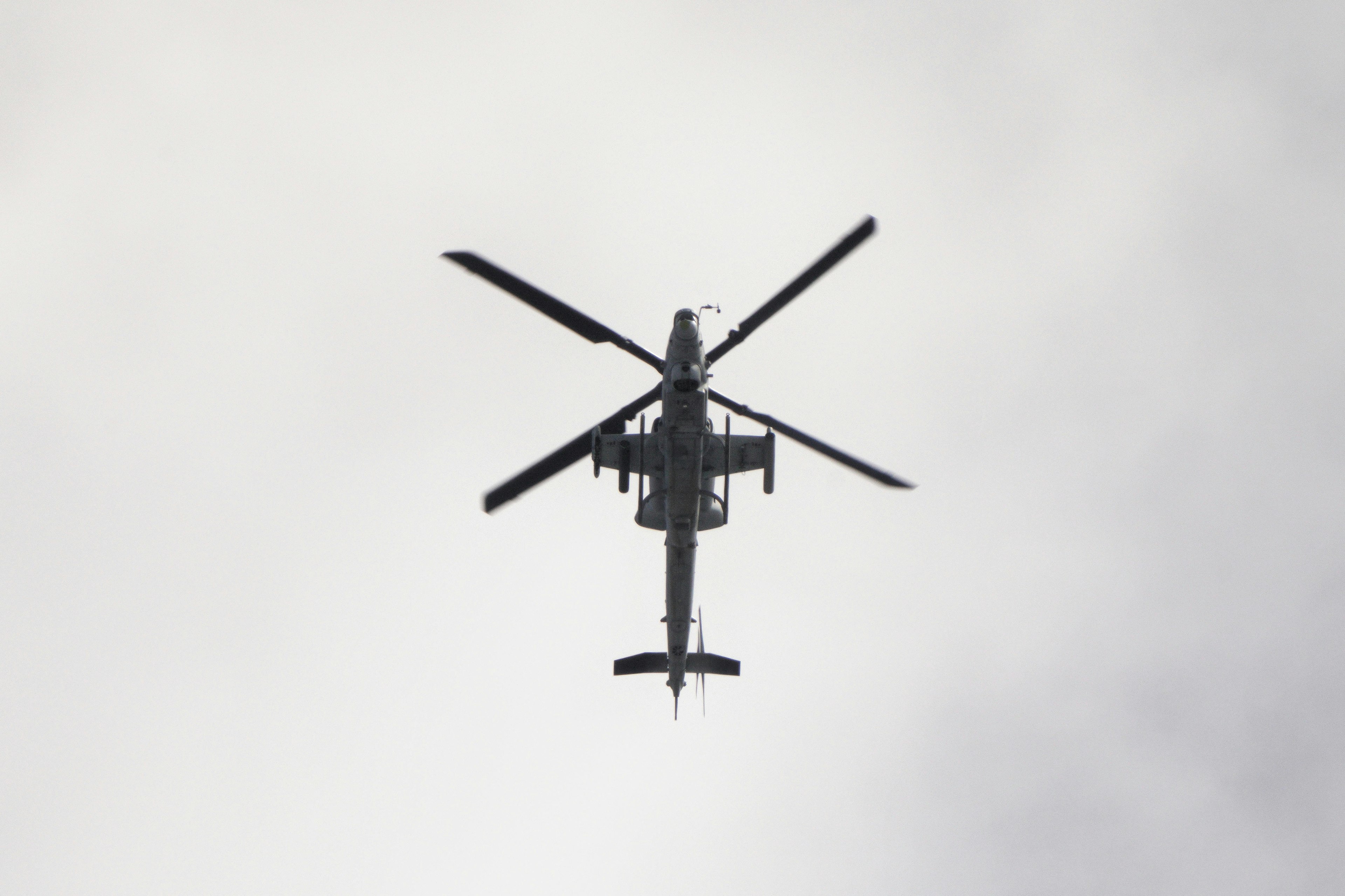 View from below of a helicopter flying in the sky