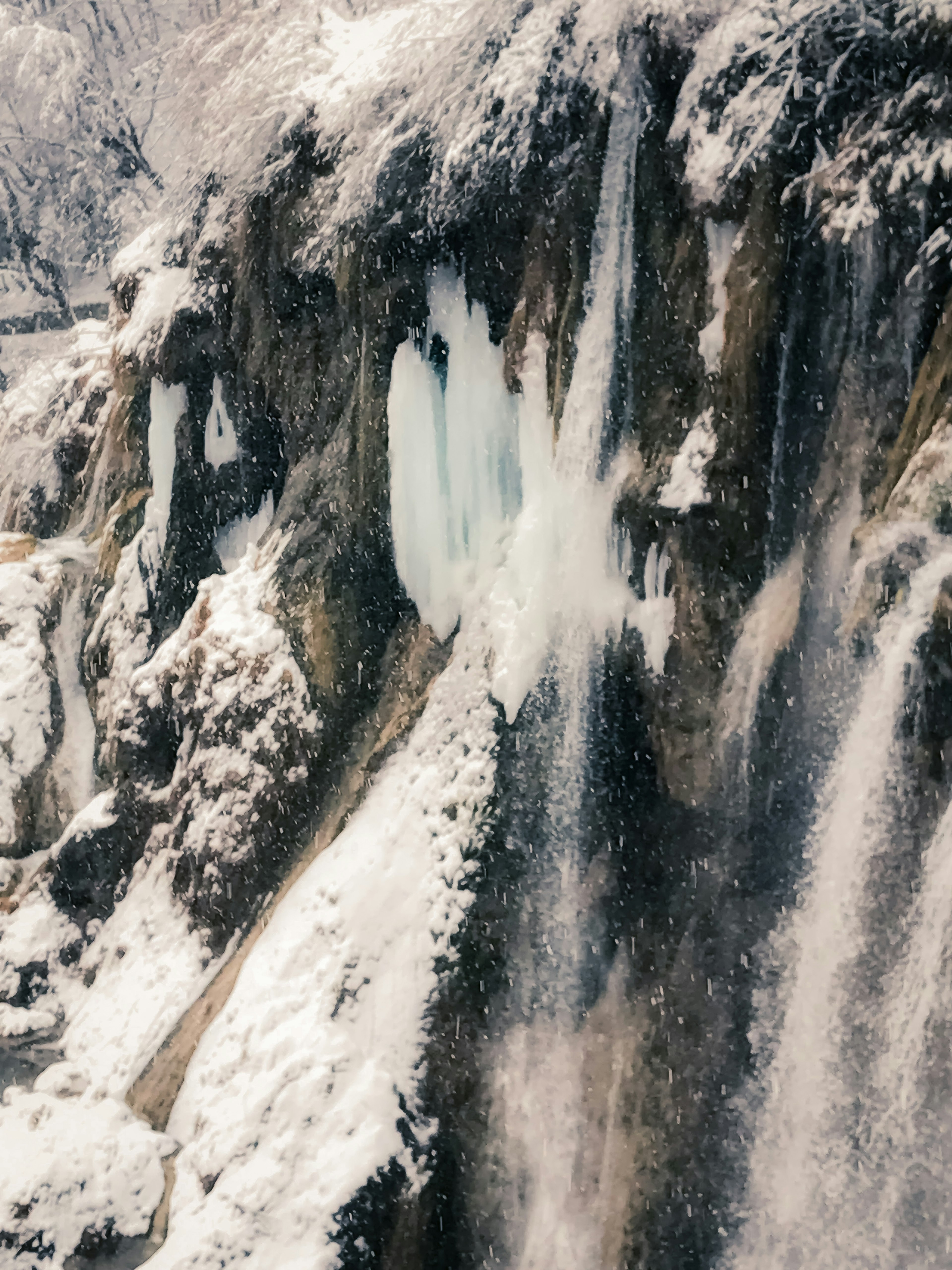 Frozen waterfall with ice formations and rocky textures