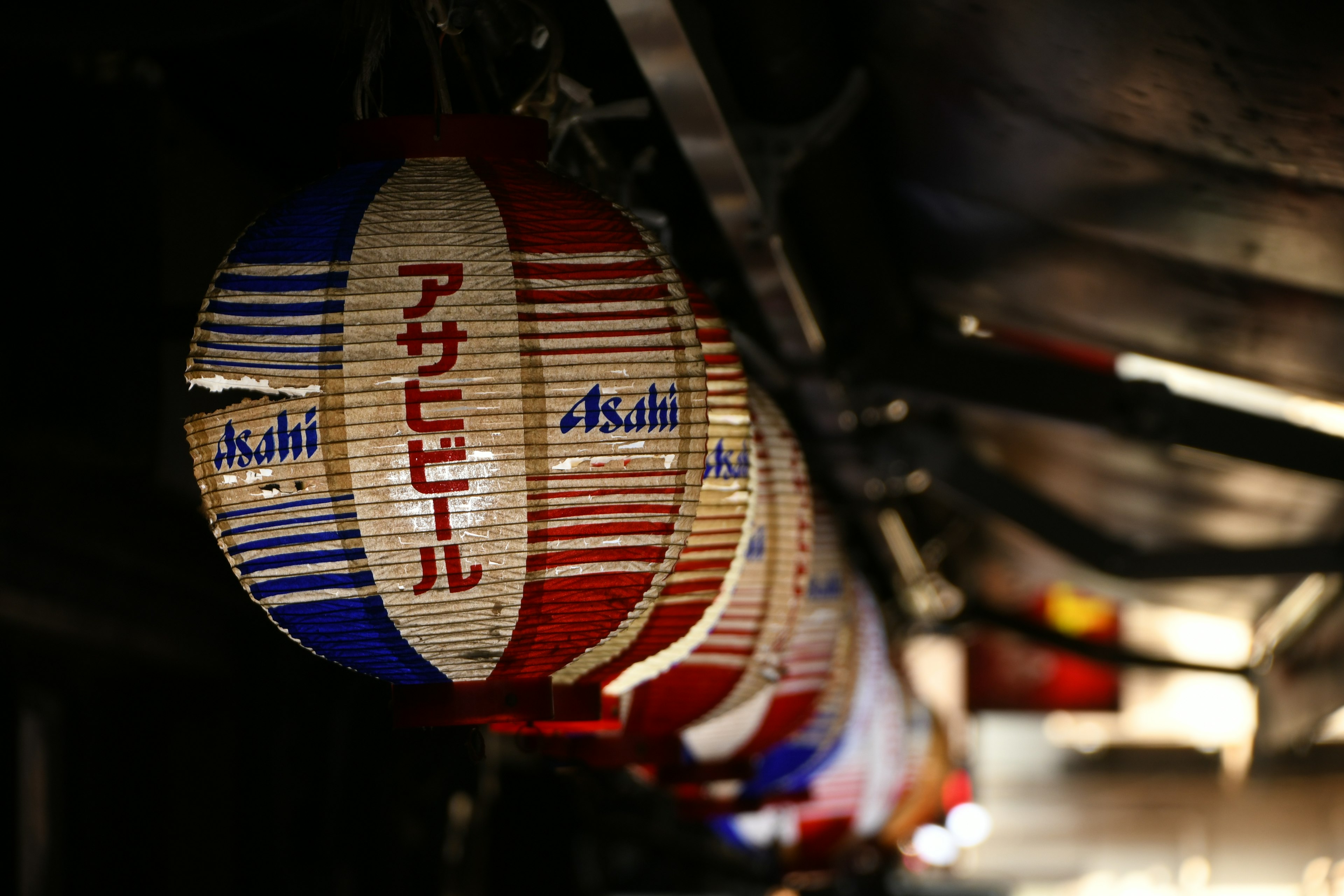 Colorful red and white lanterns hanging in a Japanese izakaya