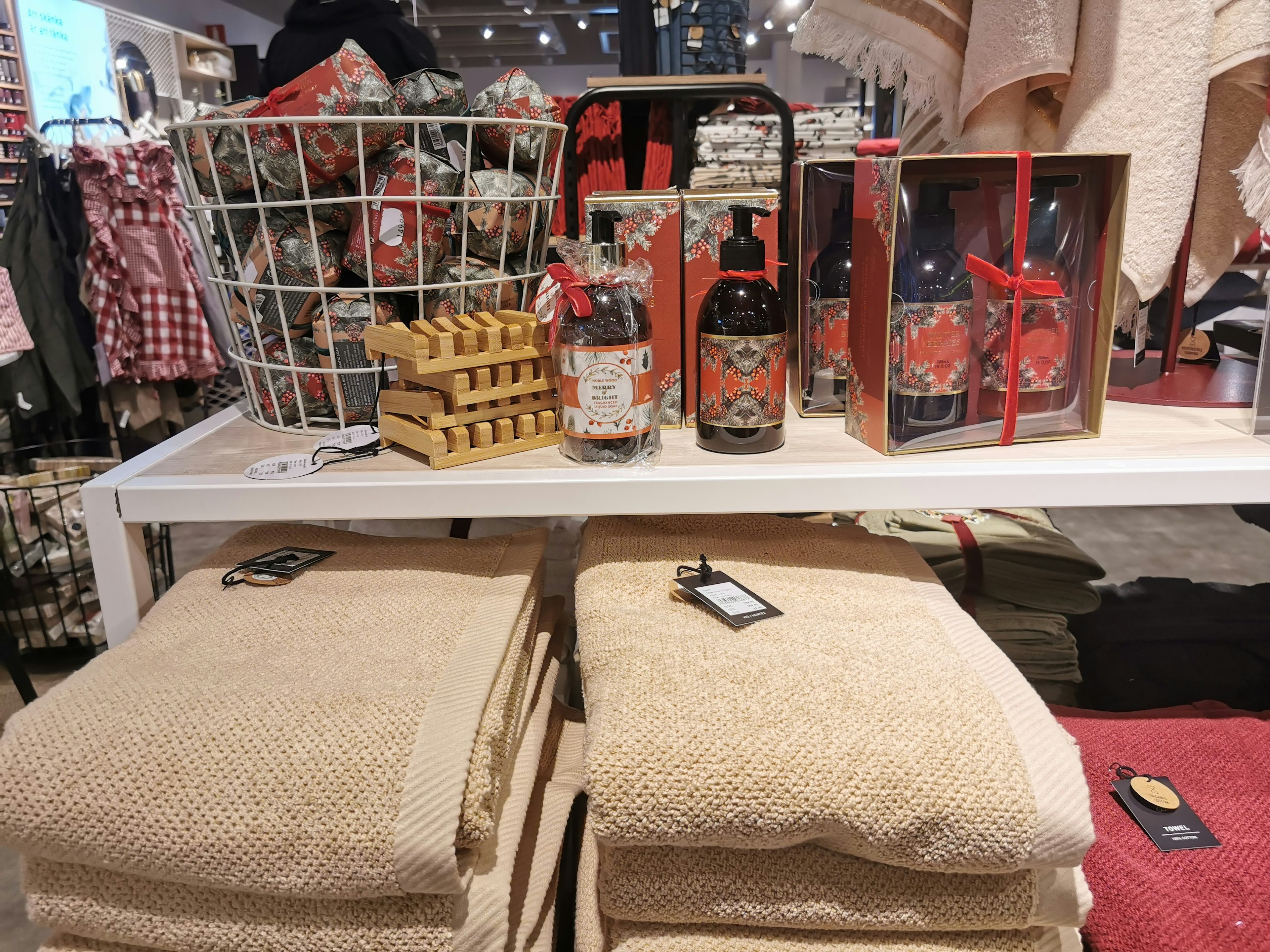 A display of towels, gift boxes, and a basket in a store