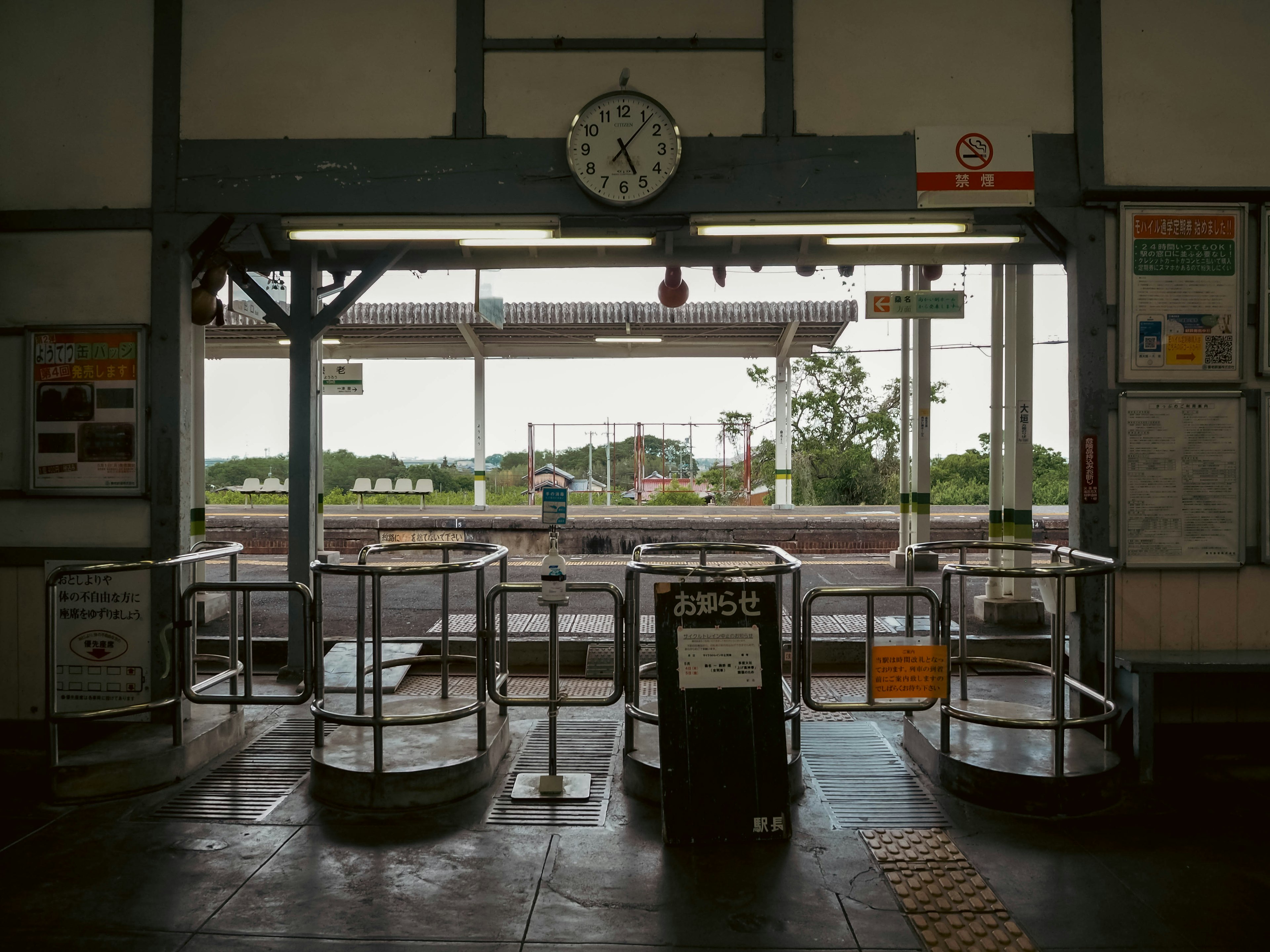 View of a train station ticket gate and clock