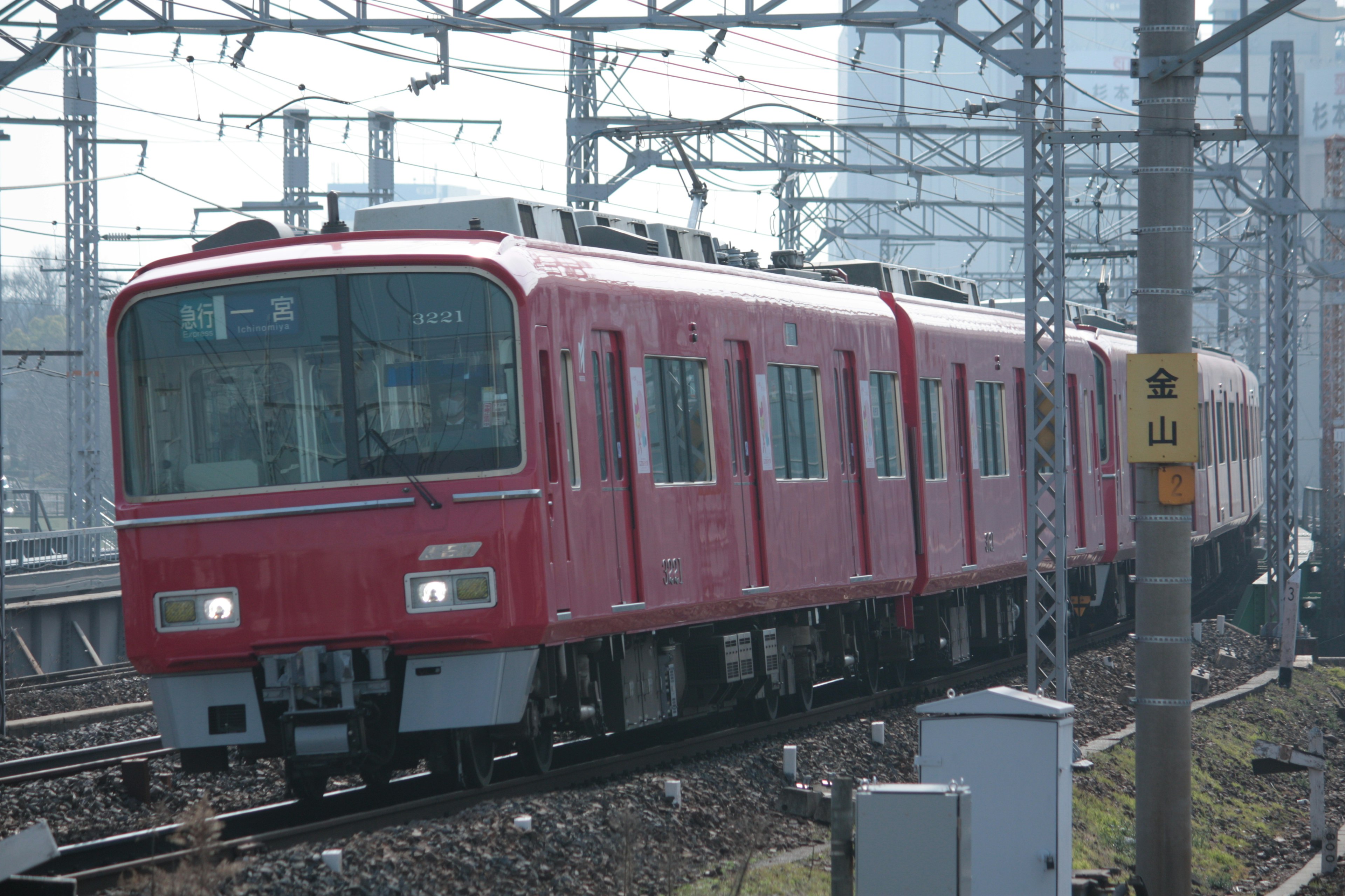 Red train traveling along the tracks