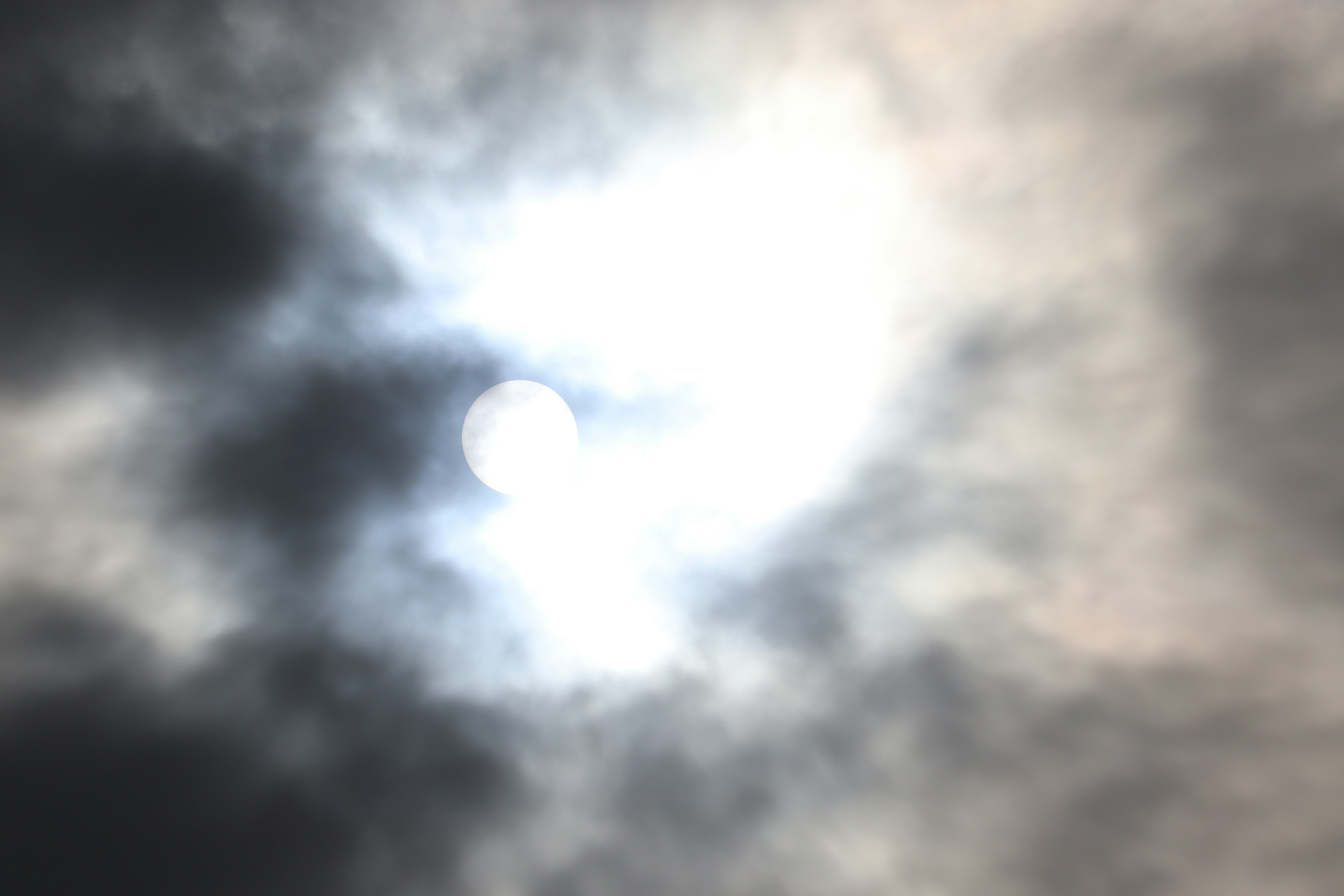 Sunlight obscured by clouds in a hazy sky