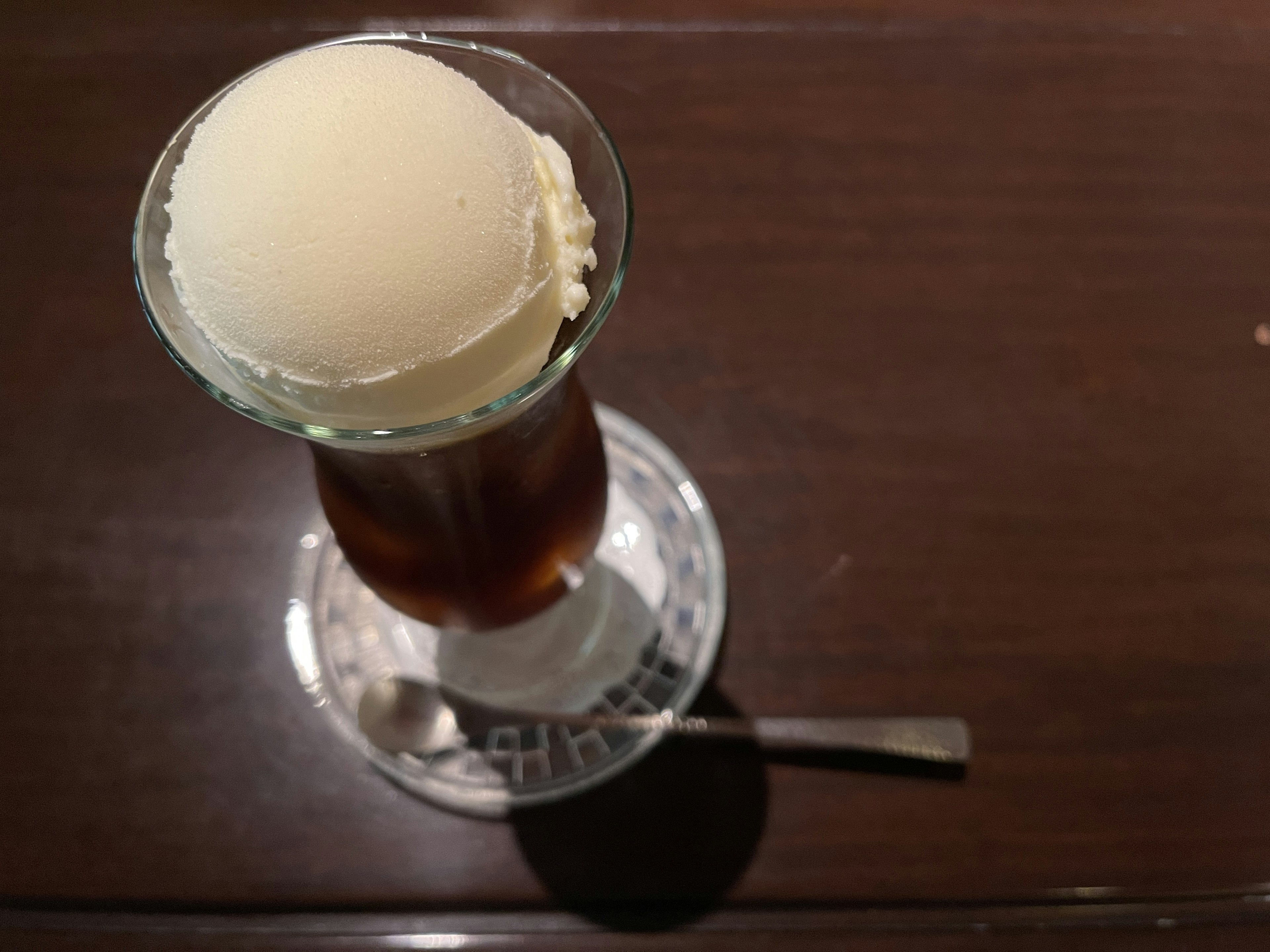 A top view of a drink topped with ice cream