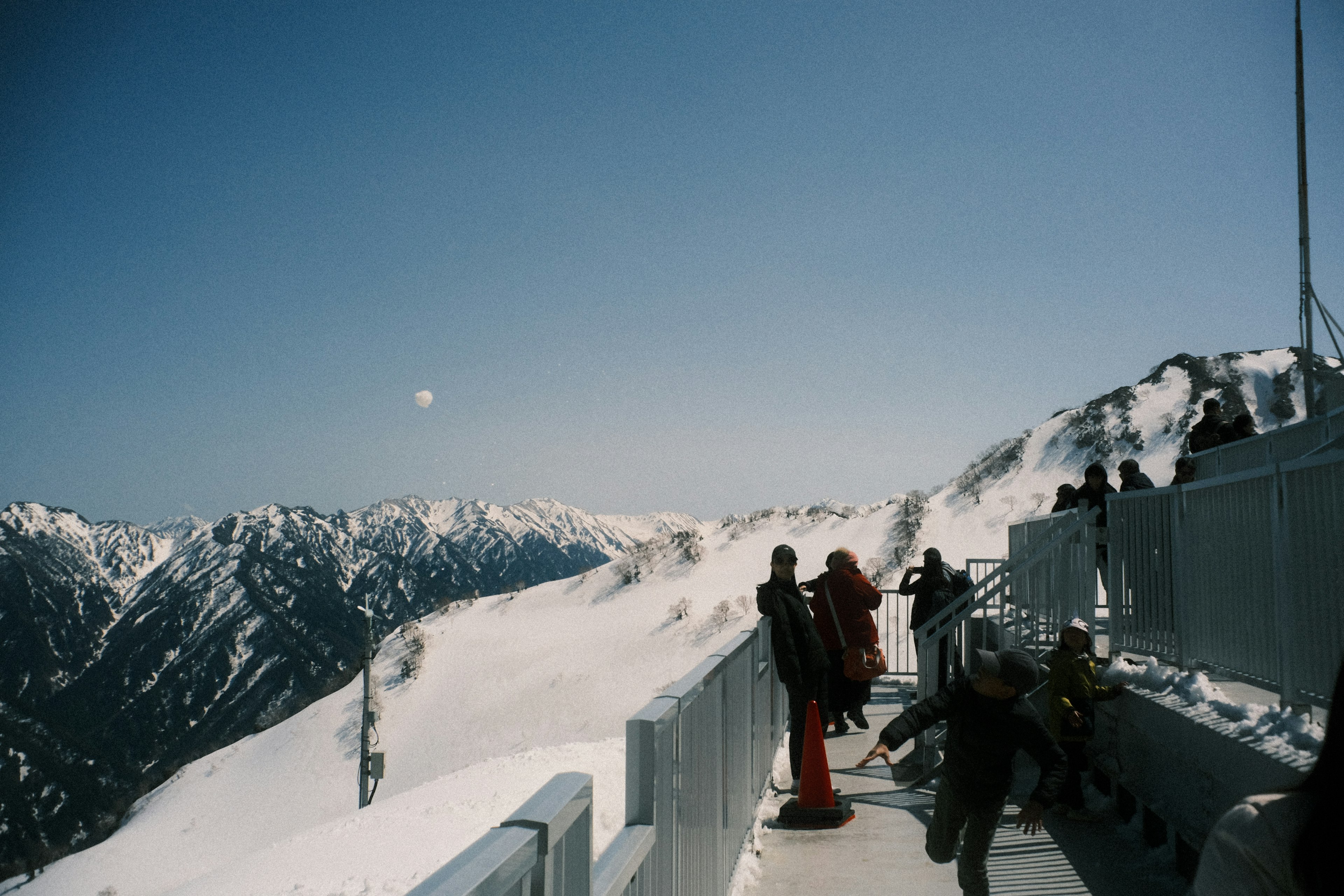 Tourists with snow-covered mountains in the background