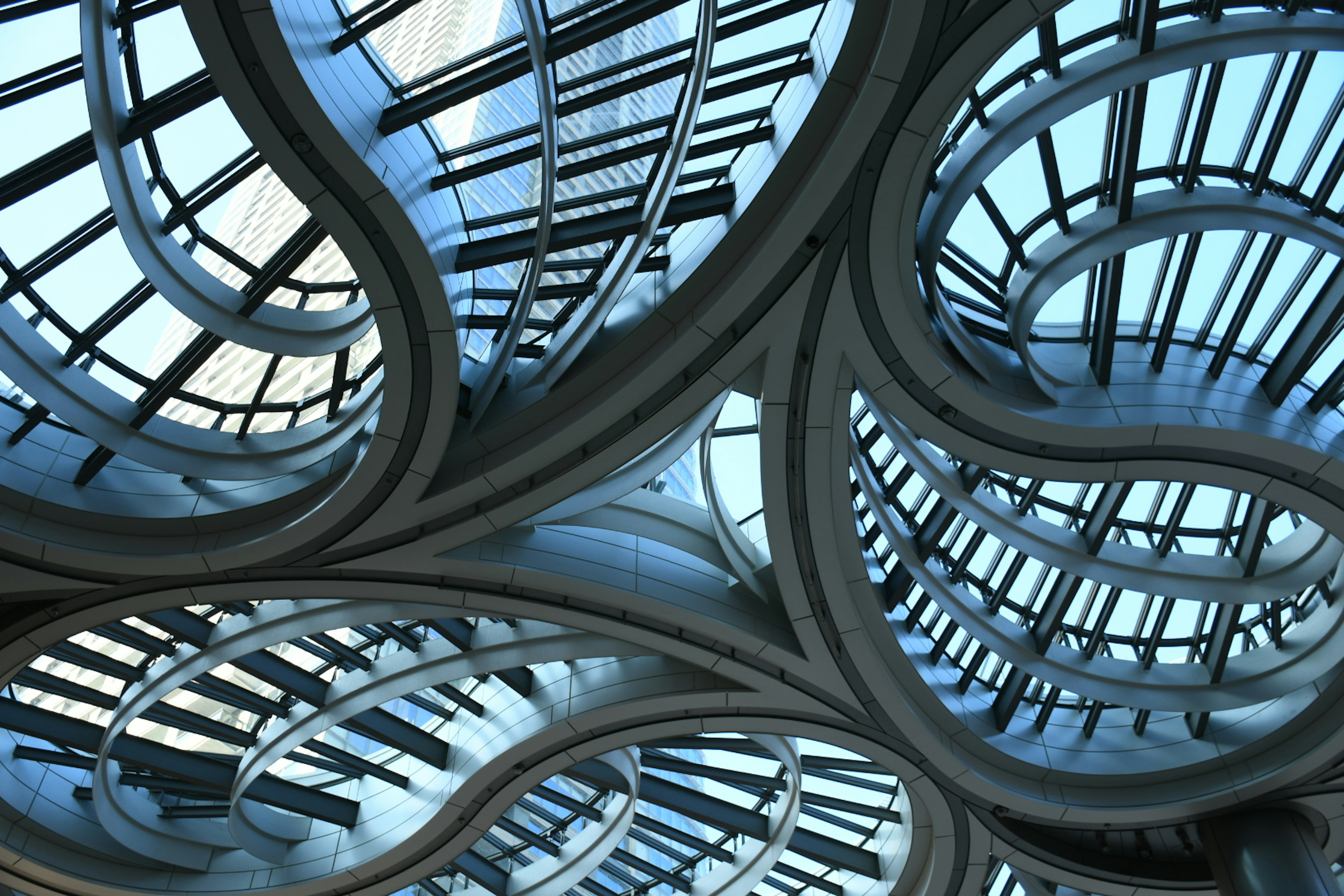 Unique wavy ceiling design with visible blue sky