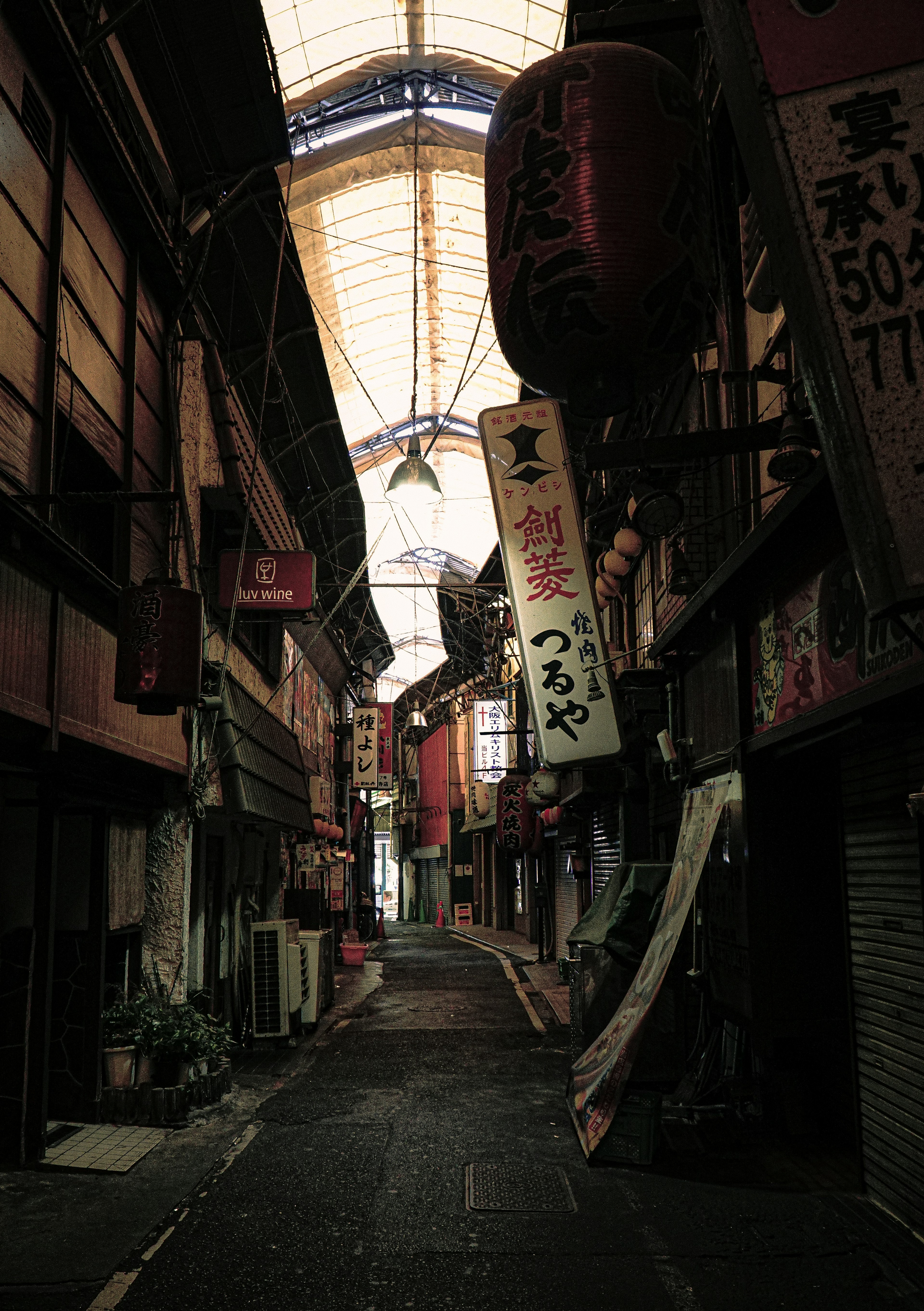 Narrow street lined with old shops and lanterns