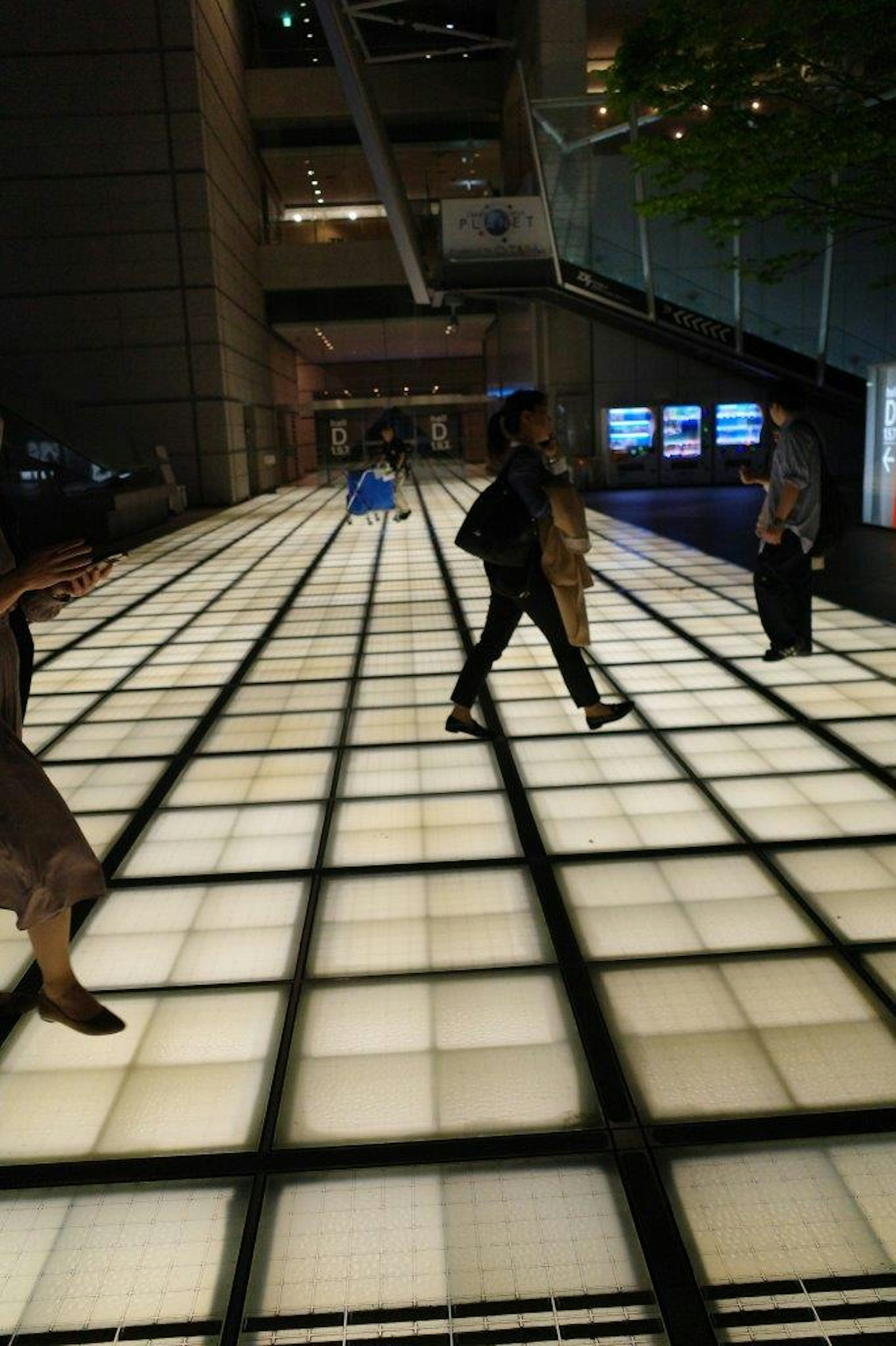 People walking on a bright floor in a modern building interior