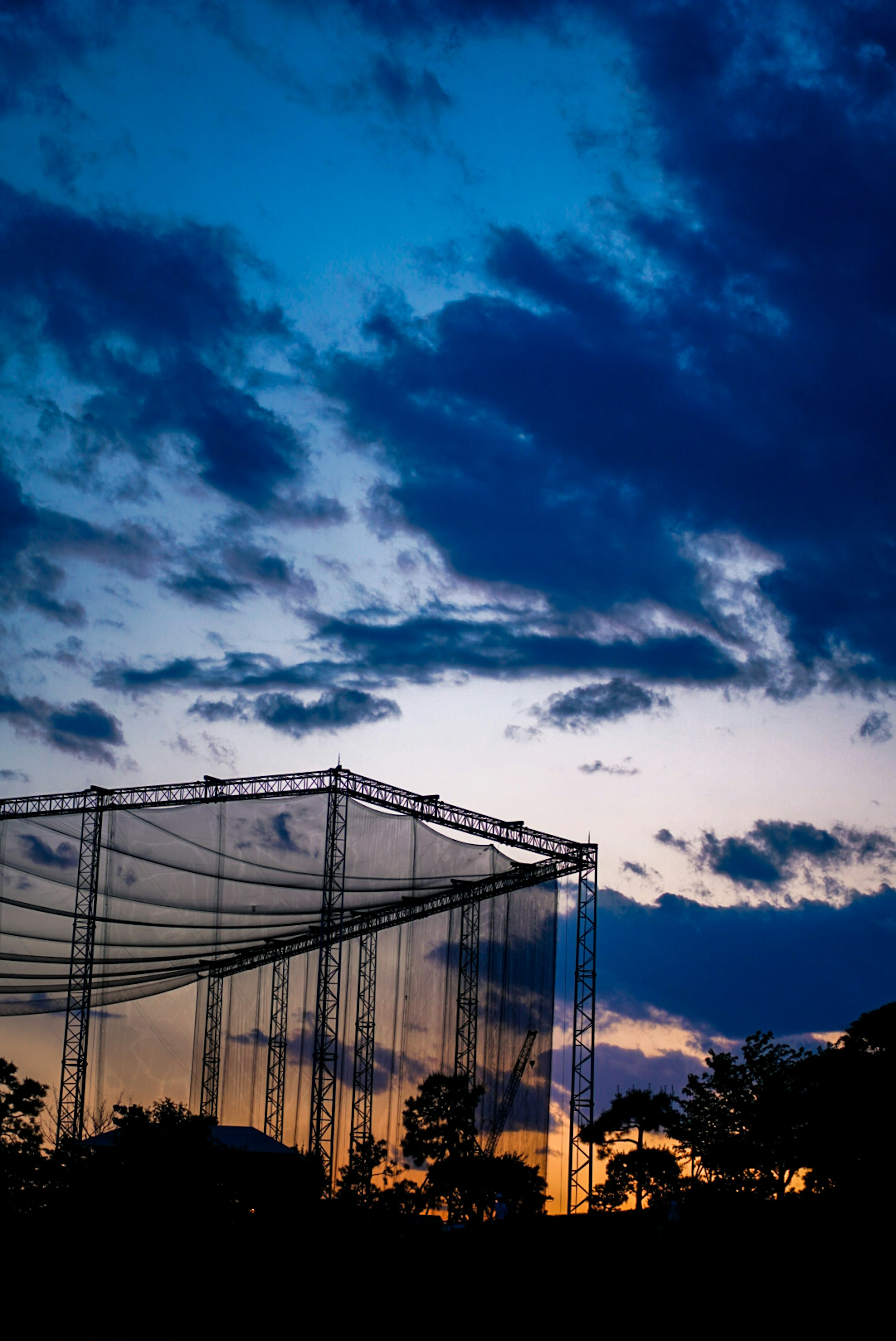 Silhouette of a net against a sunset sky