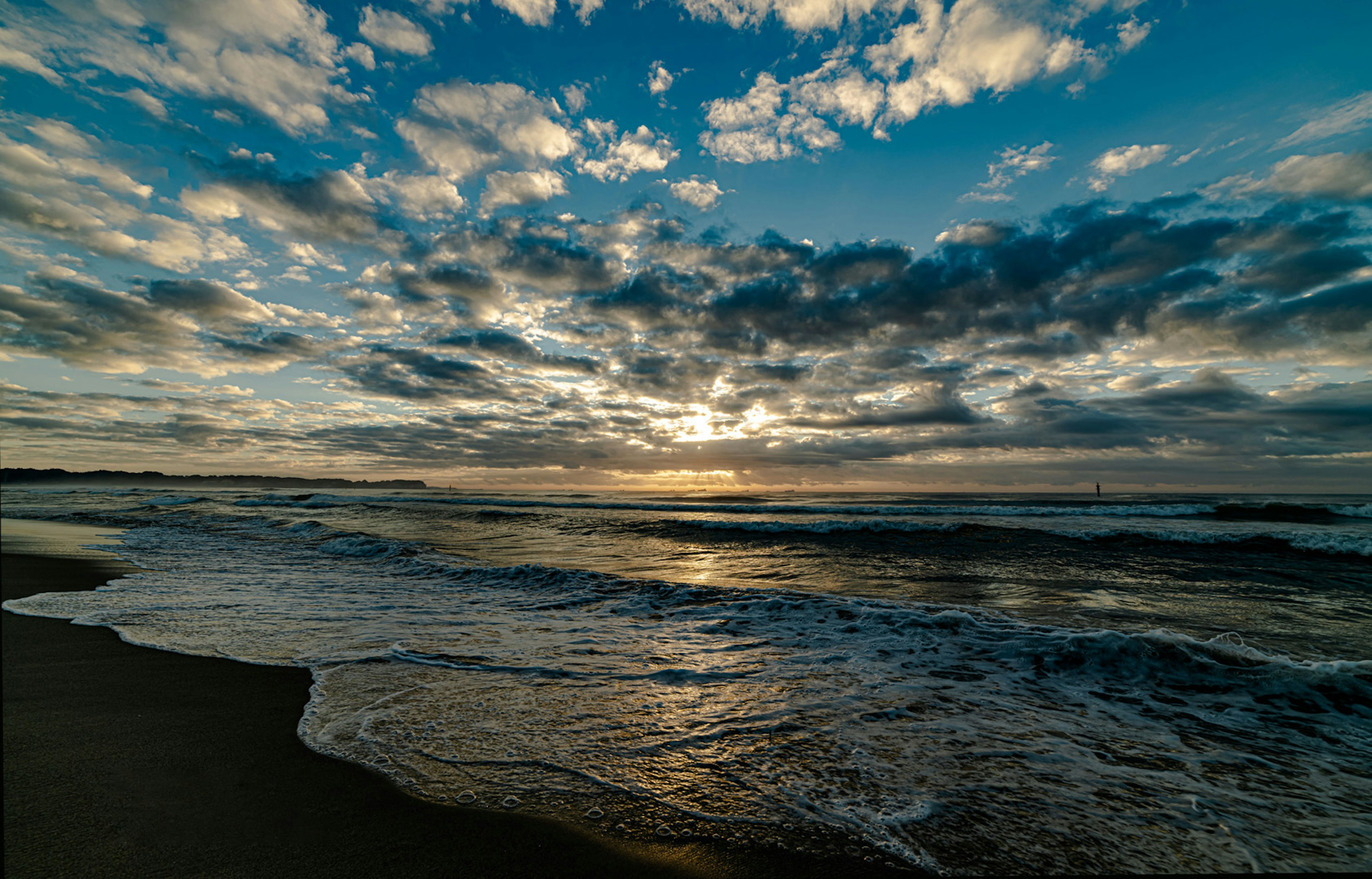 Beautiful sunset sky over the coastline with waves