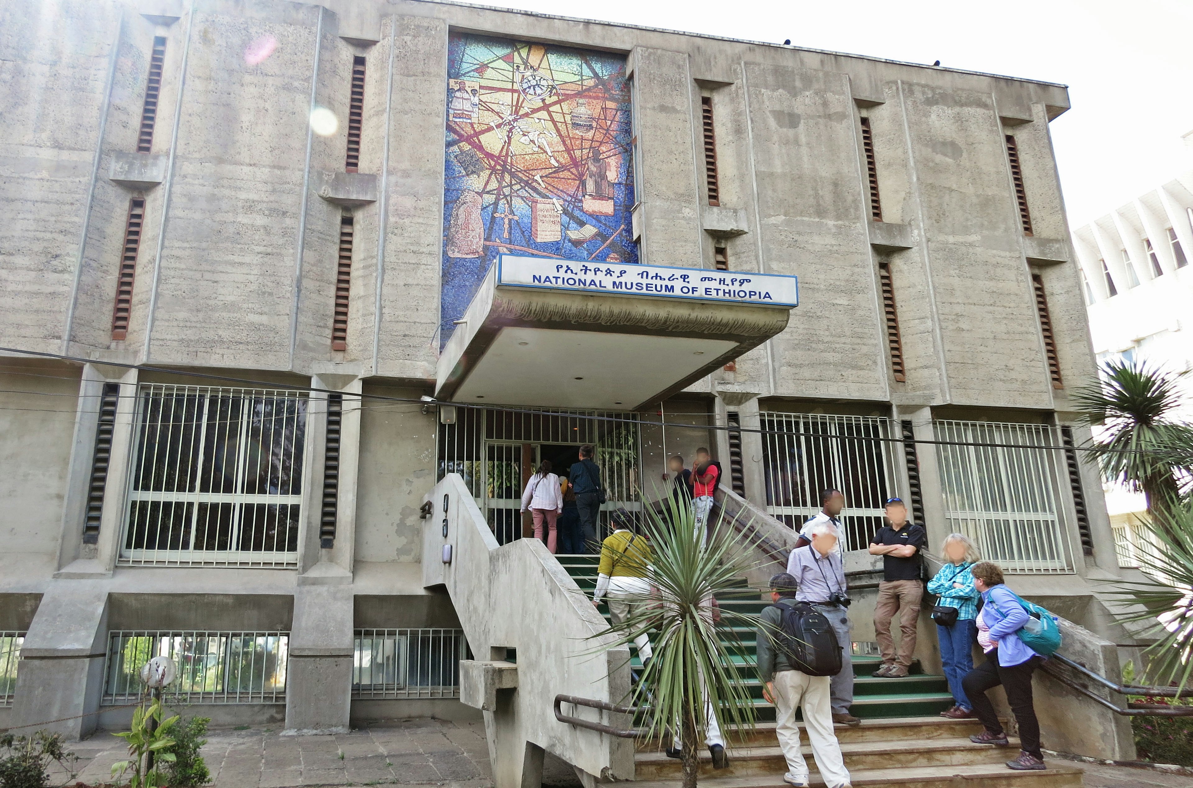 Exterior view of a building with people entering and exiting