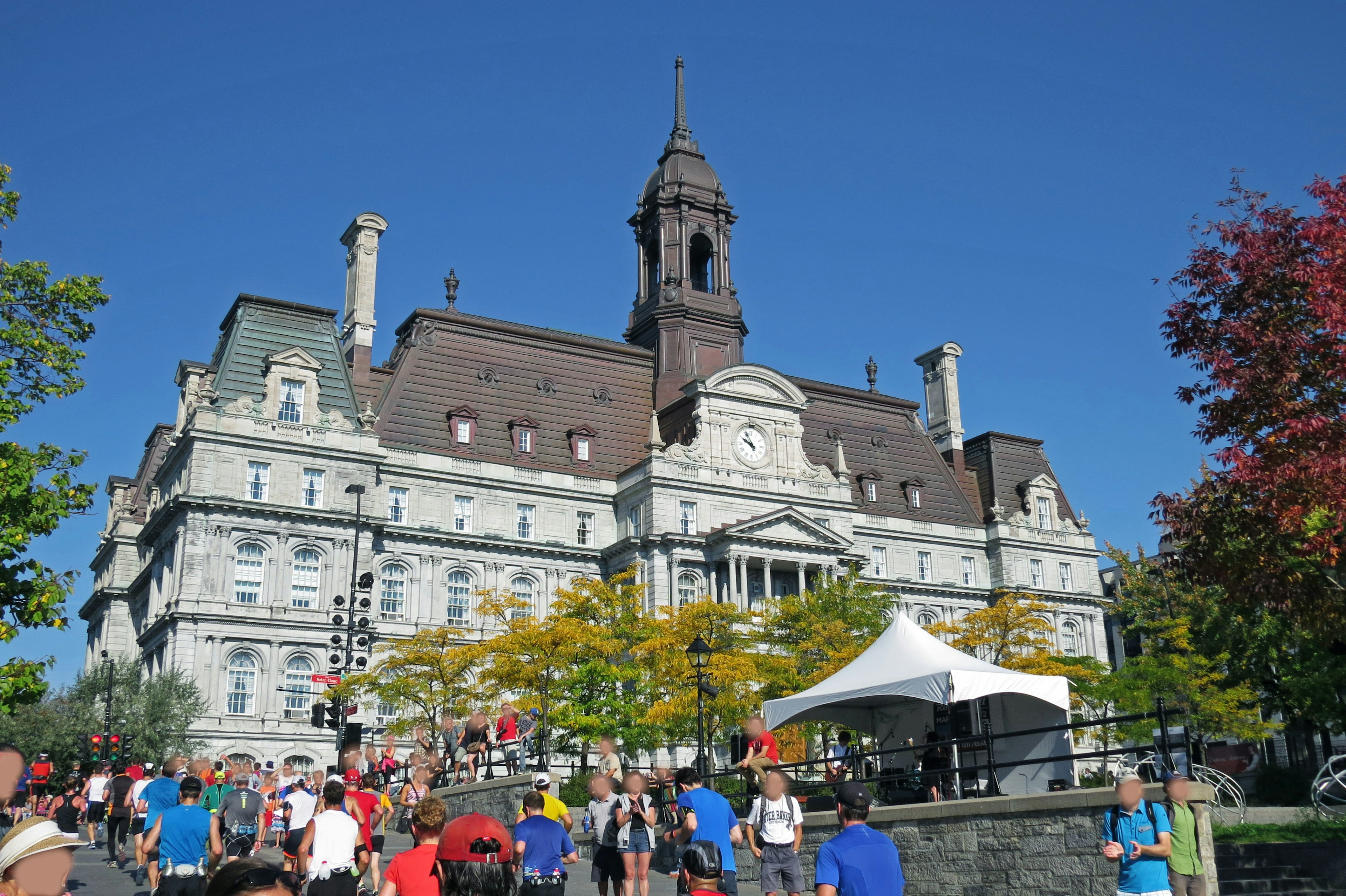 Montreal City Hall's stunning architecture with people gathering under a blue sky