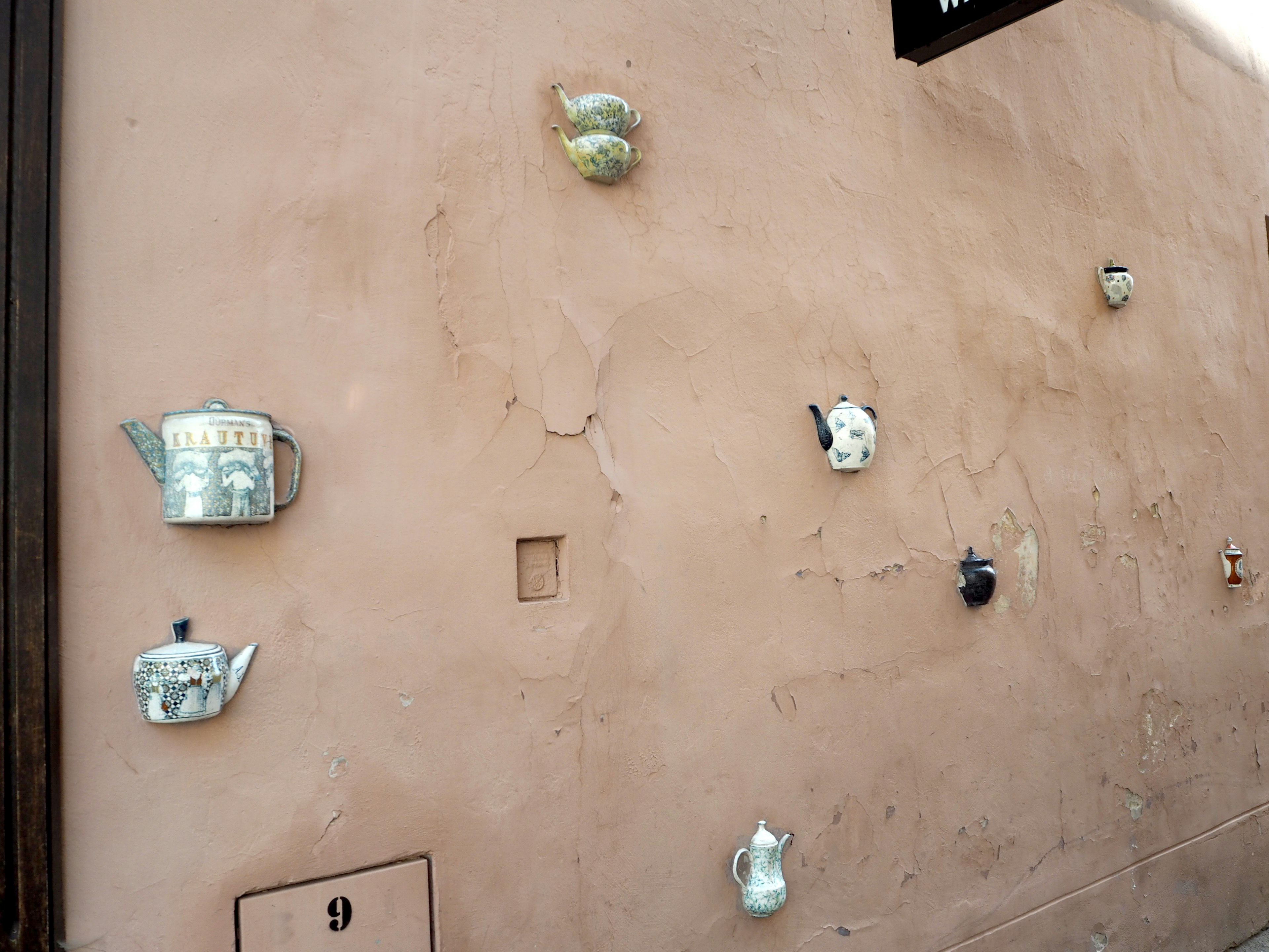 Art installation of teapots mounted on a wall