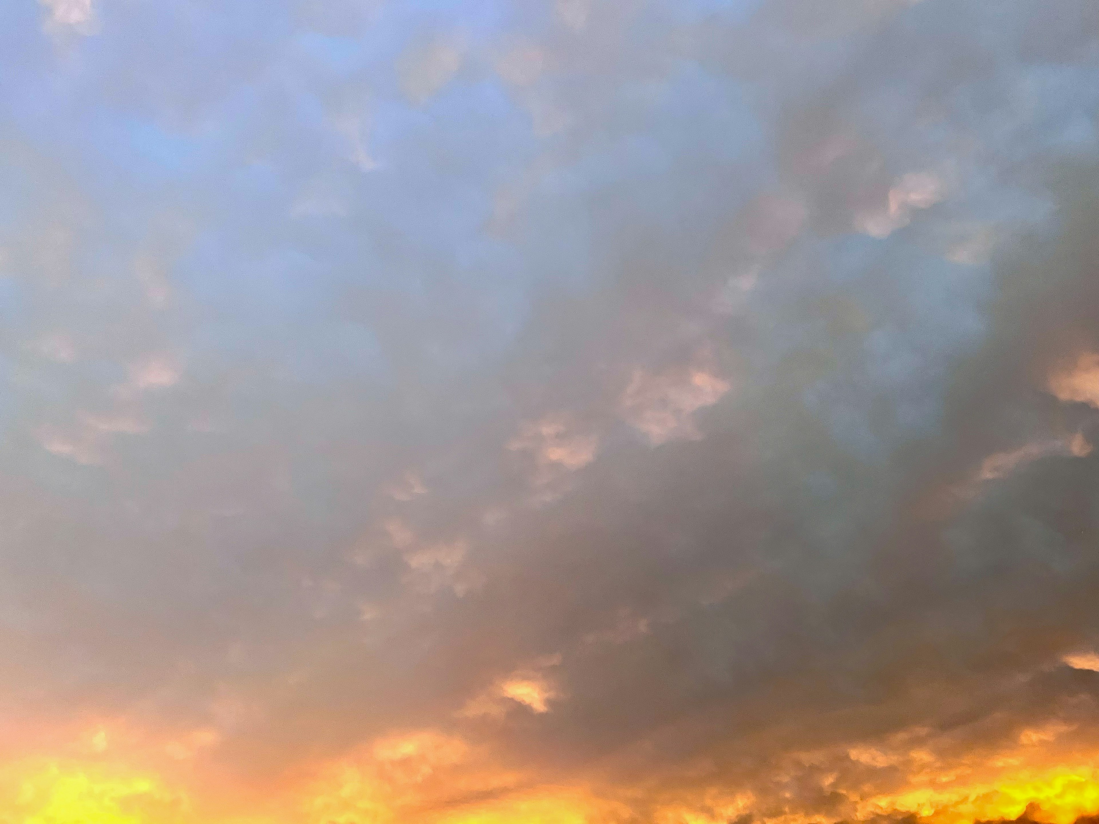 Blue sky with orange sunset clouds