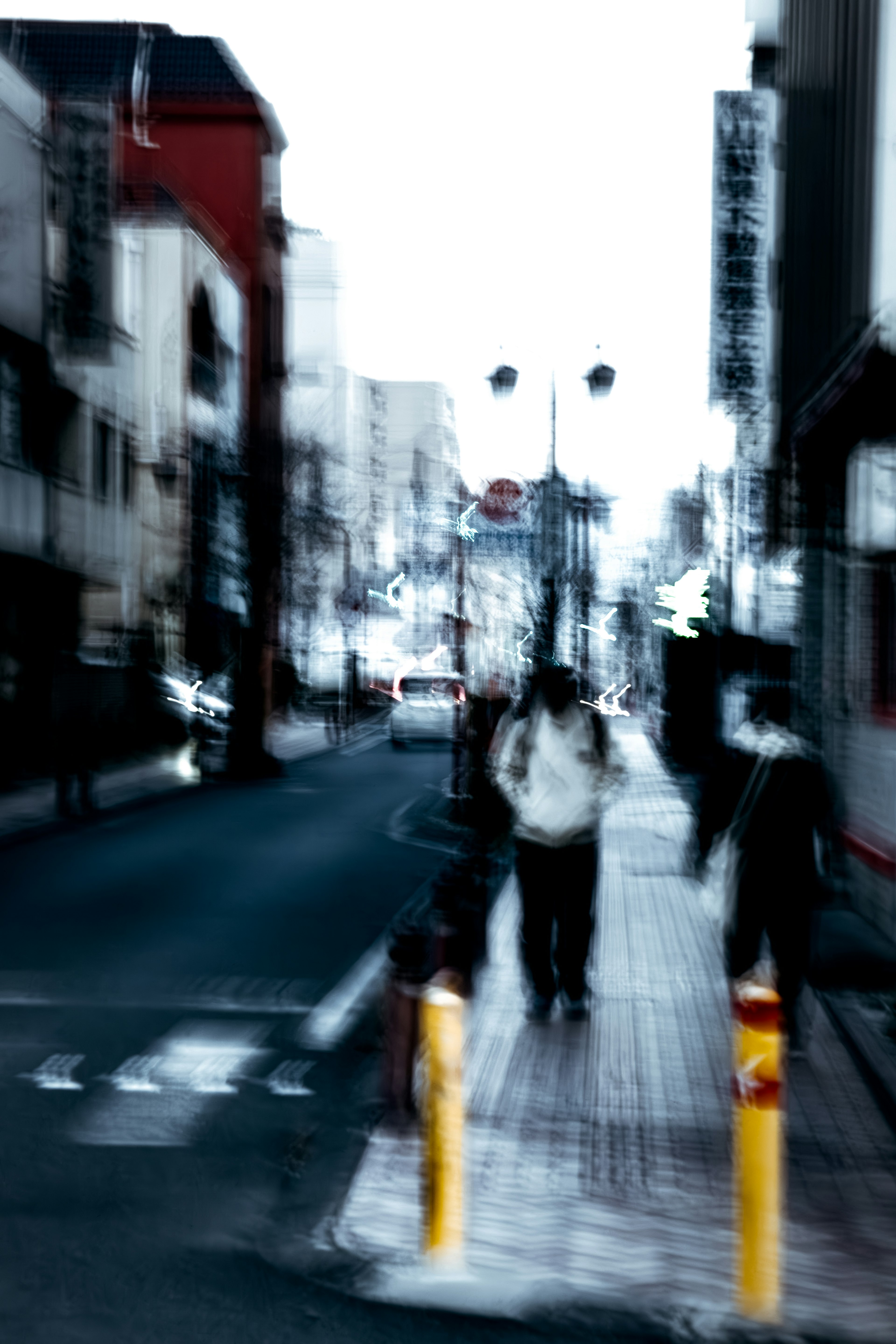 Blurred city street with silhouettes of pedestrians