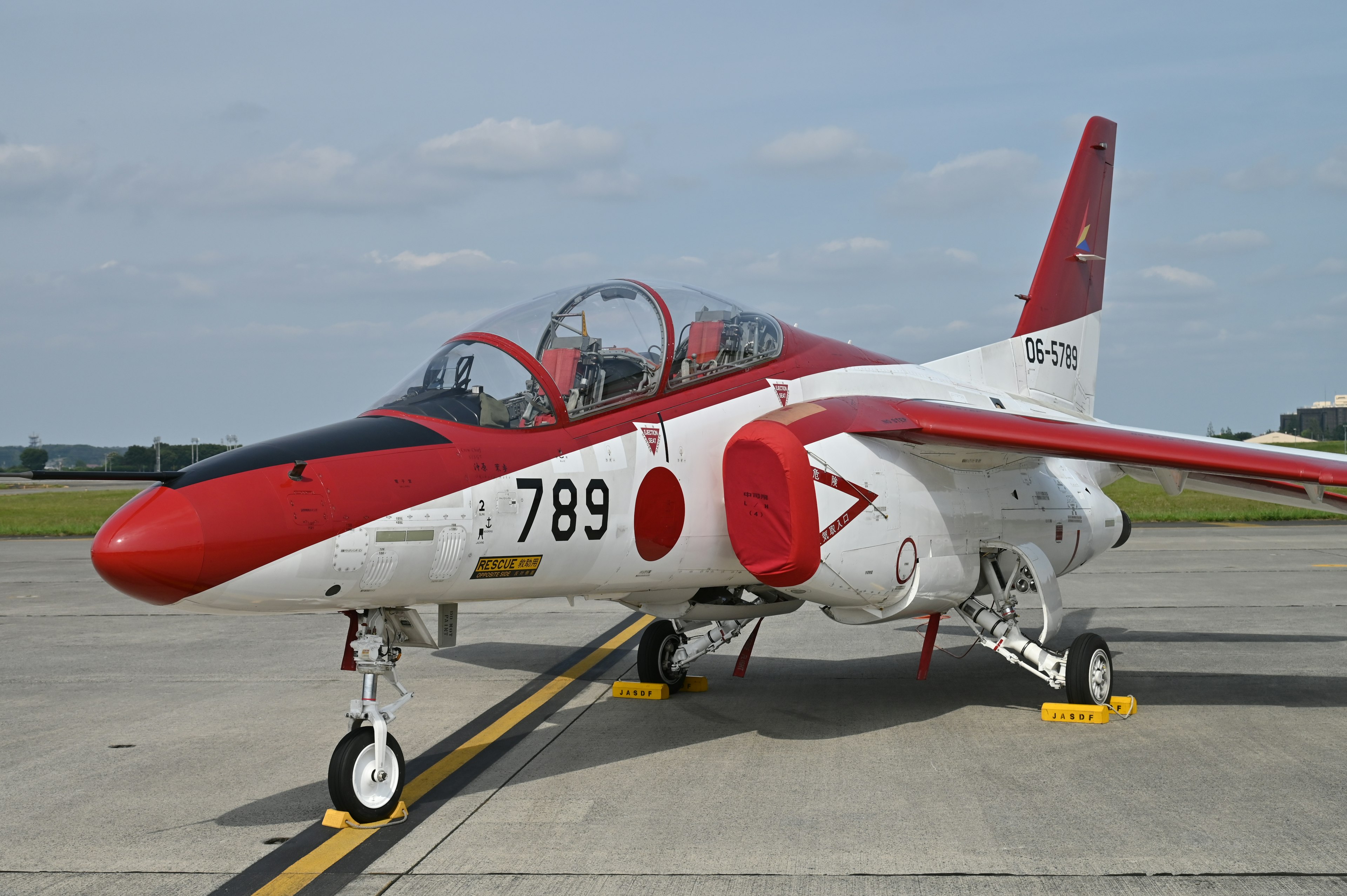 Red and white aircraft on the runway