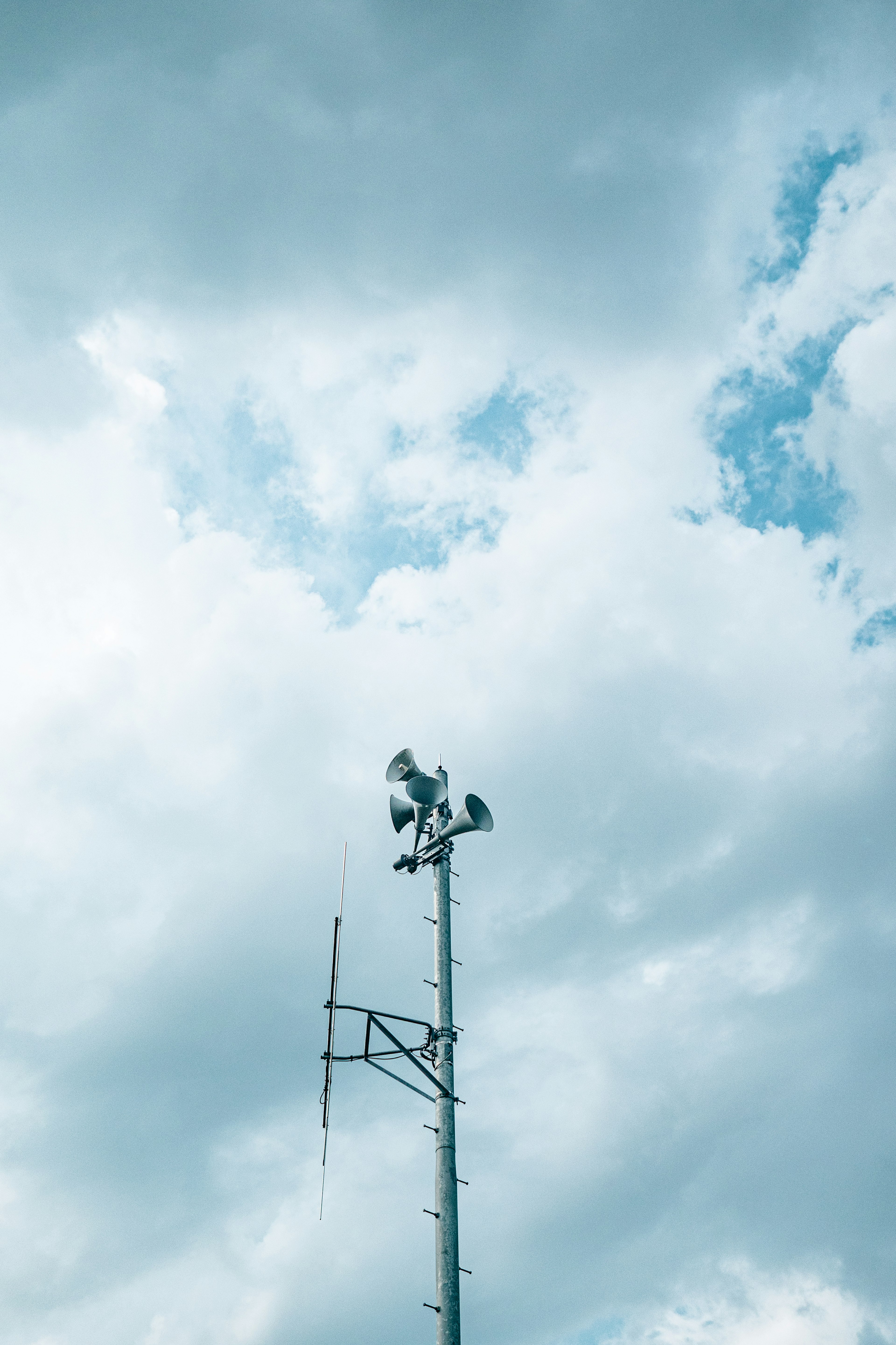 Weather observation tower against a backdrop of blue sky and clouds