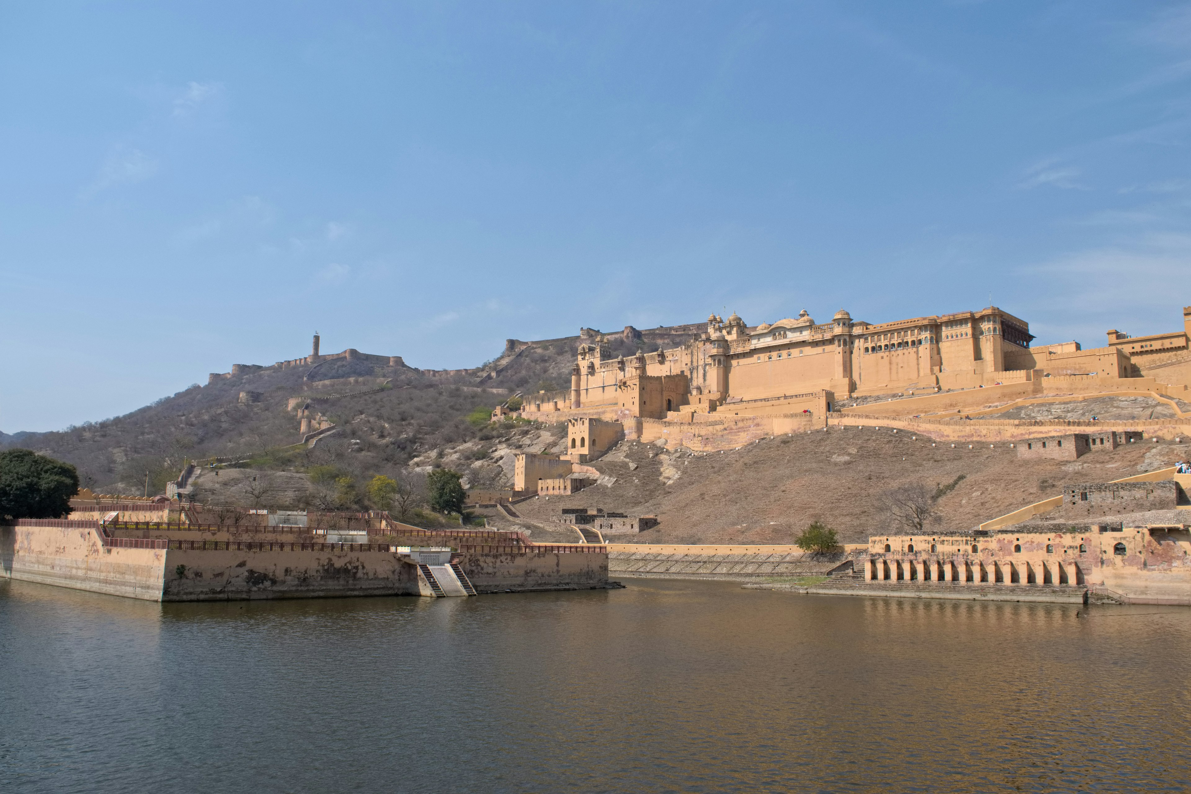 Scenic view of Amber Fort and surrounding landscape with a lake