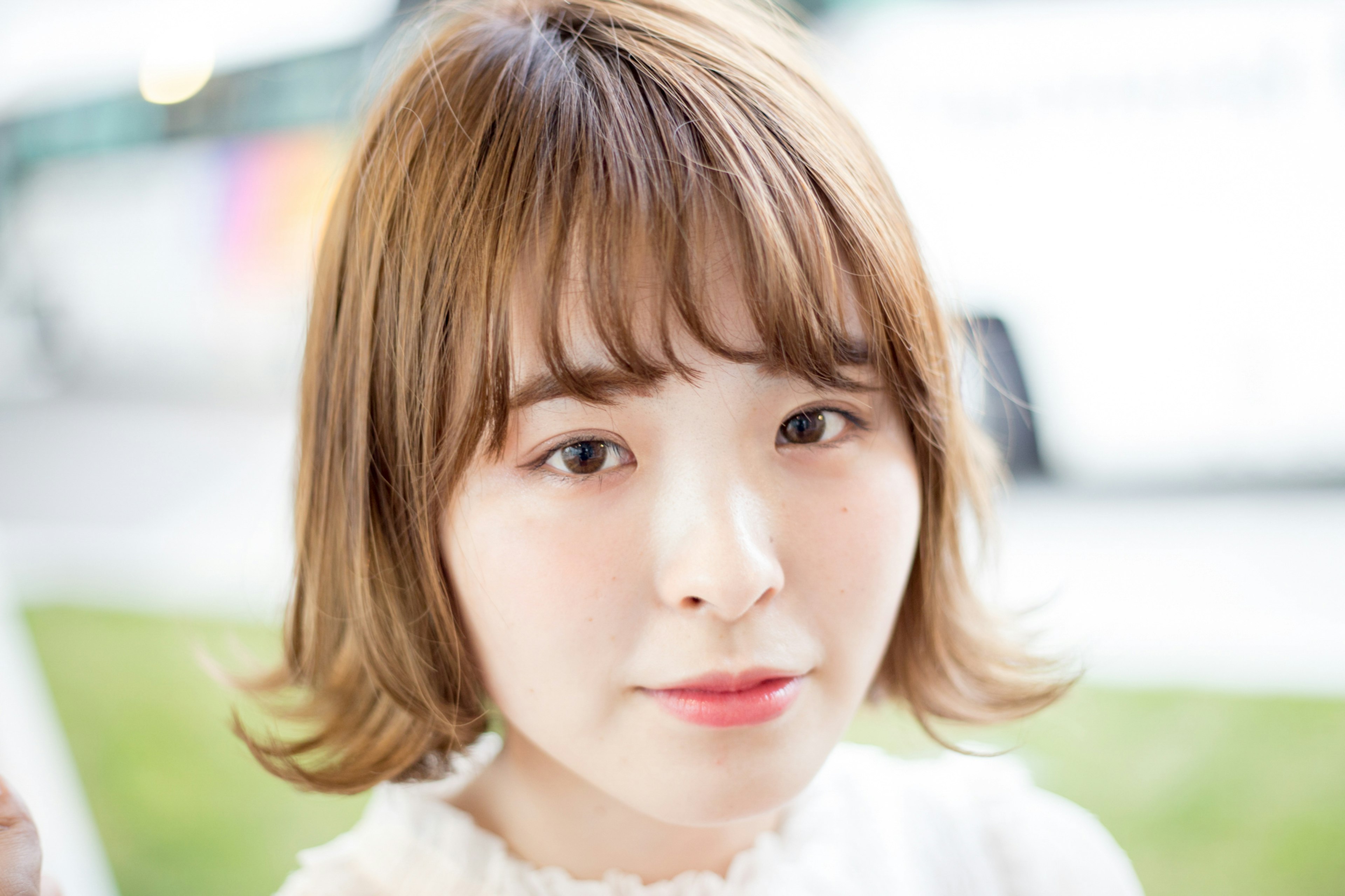 Portrait of a woman with soft brown hair Bright background and natural expression