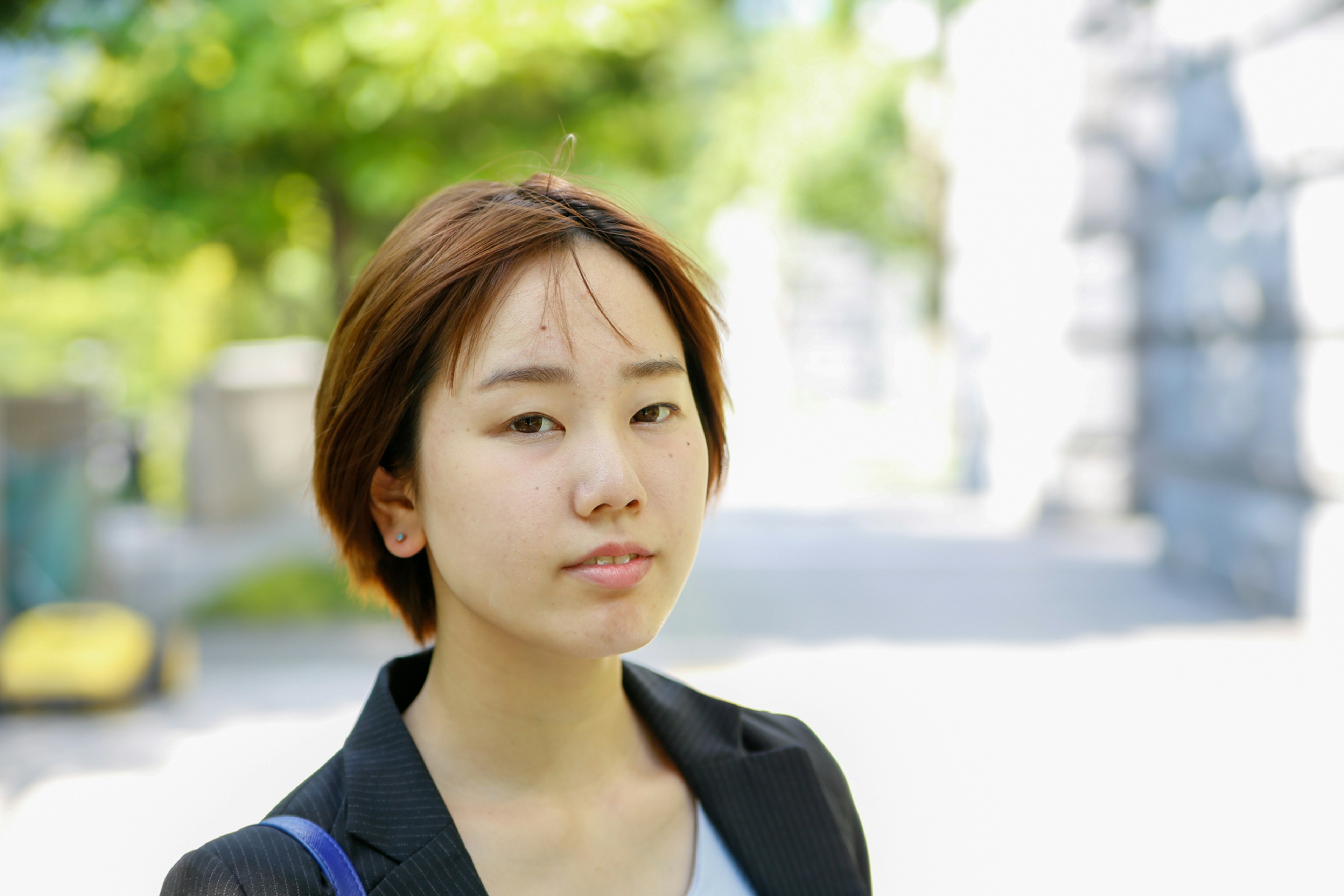 Portrait of a young woman smiling in a park