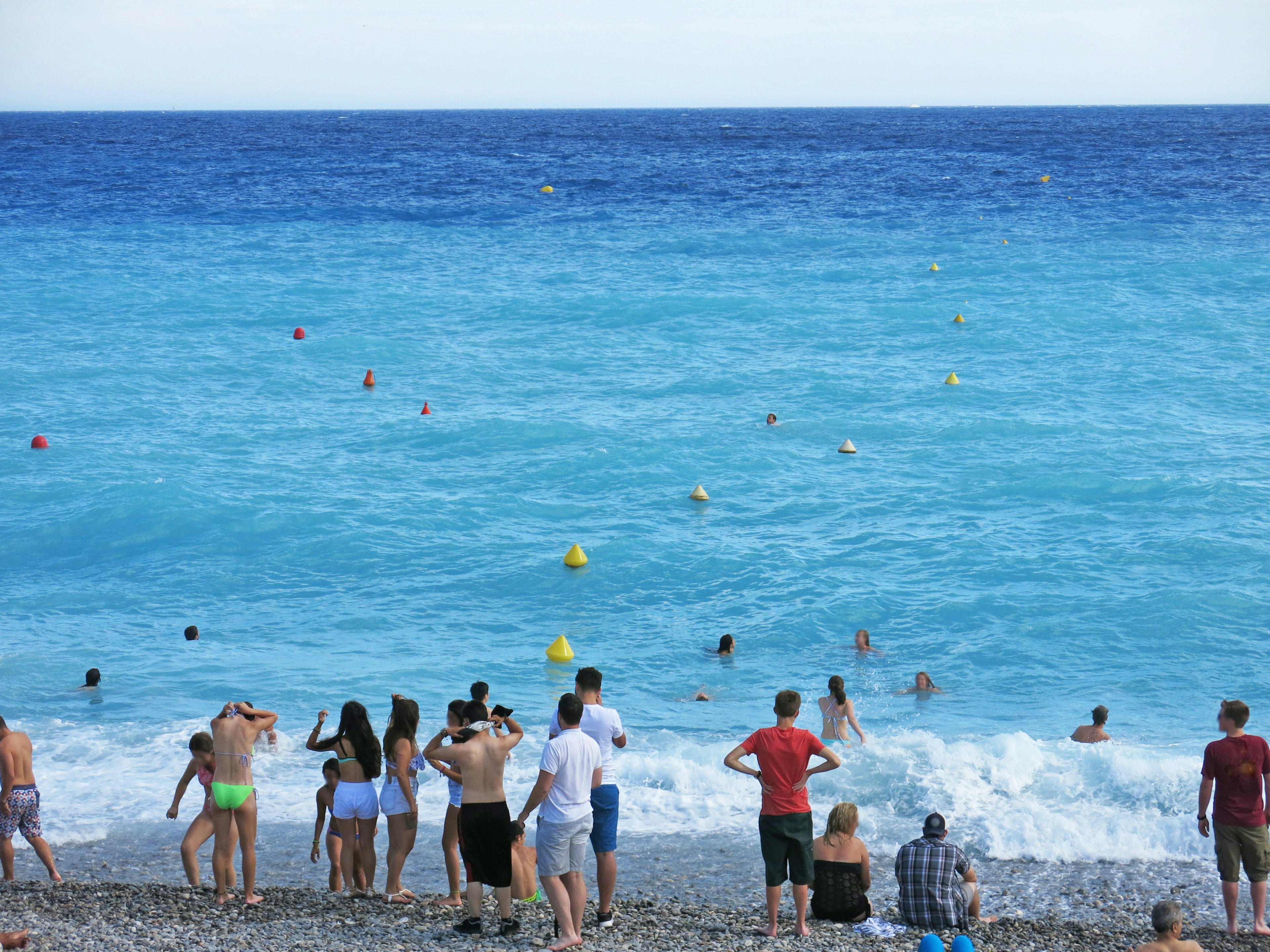 Beach scene with people enjoying the turquoise sea