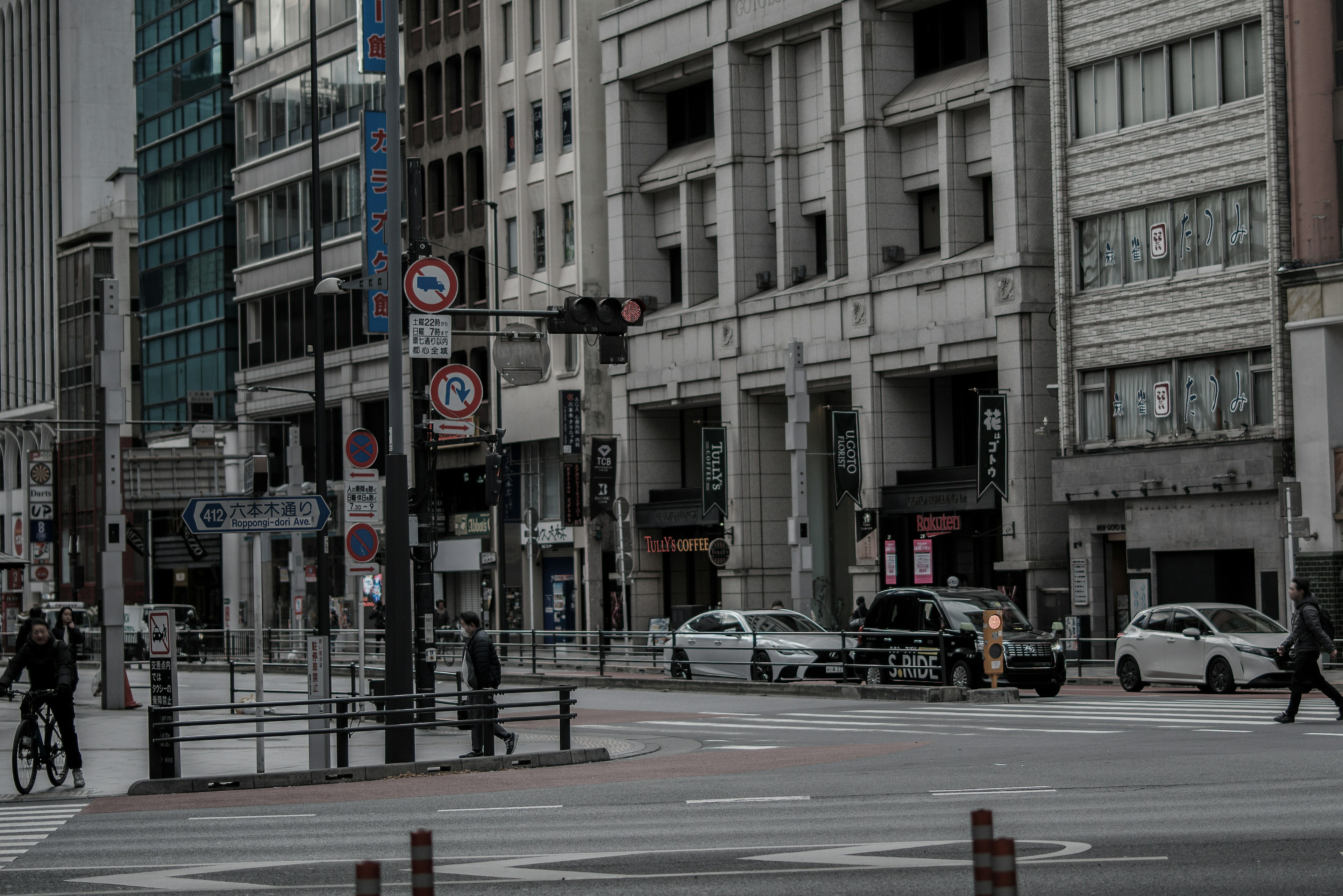 A city intersection featuring pedestrians and vehicles Modern buildings alongside traditional architecture