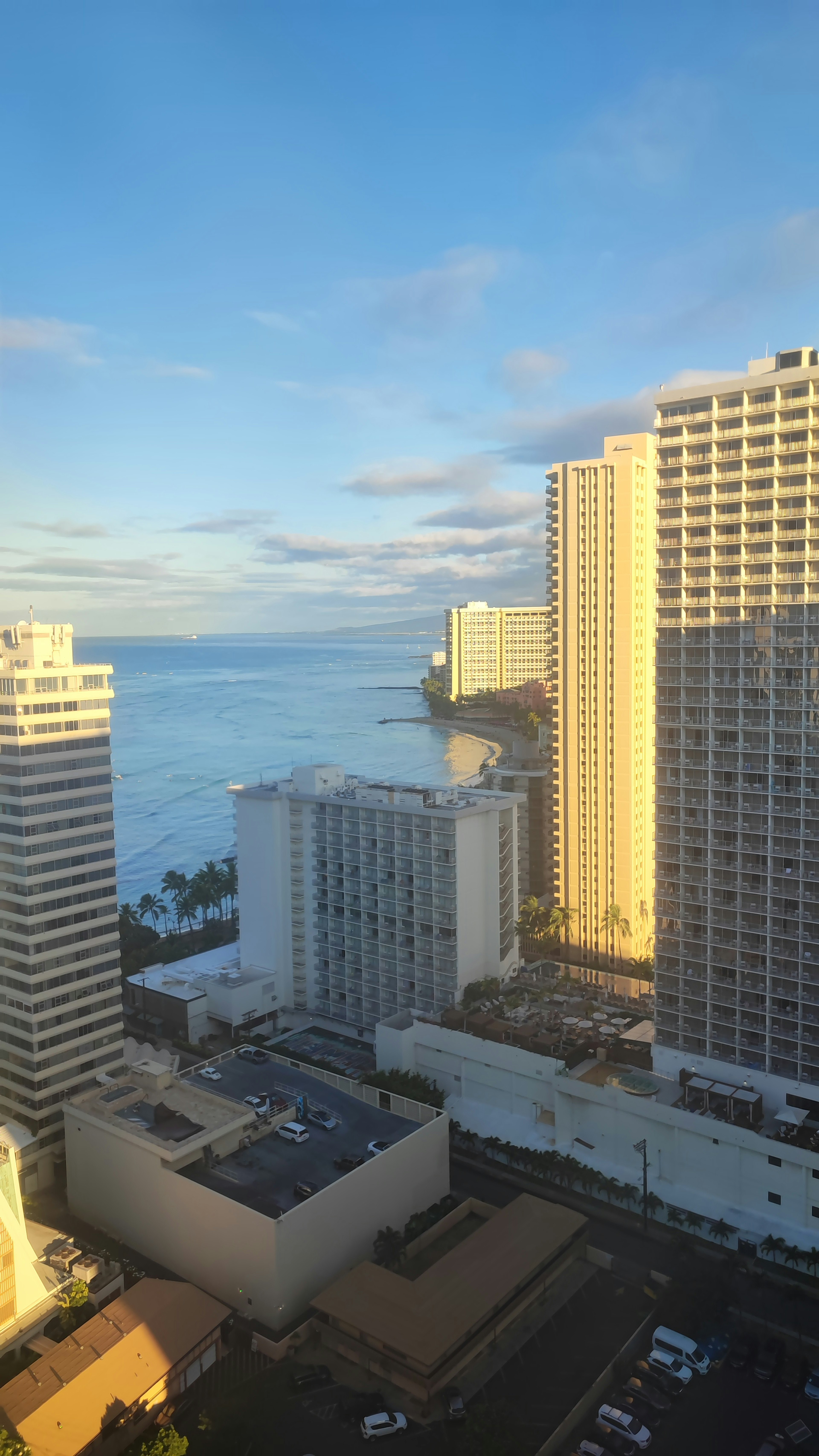 Bright sky with high-rise buildings and ocean view