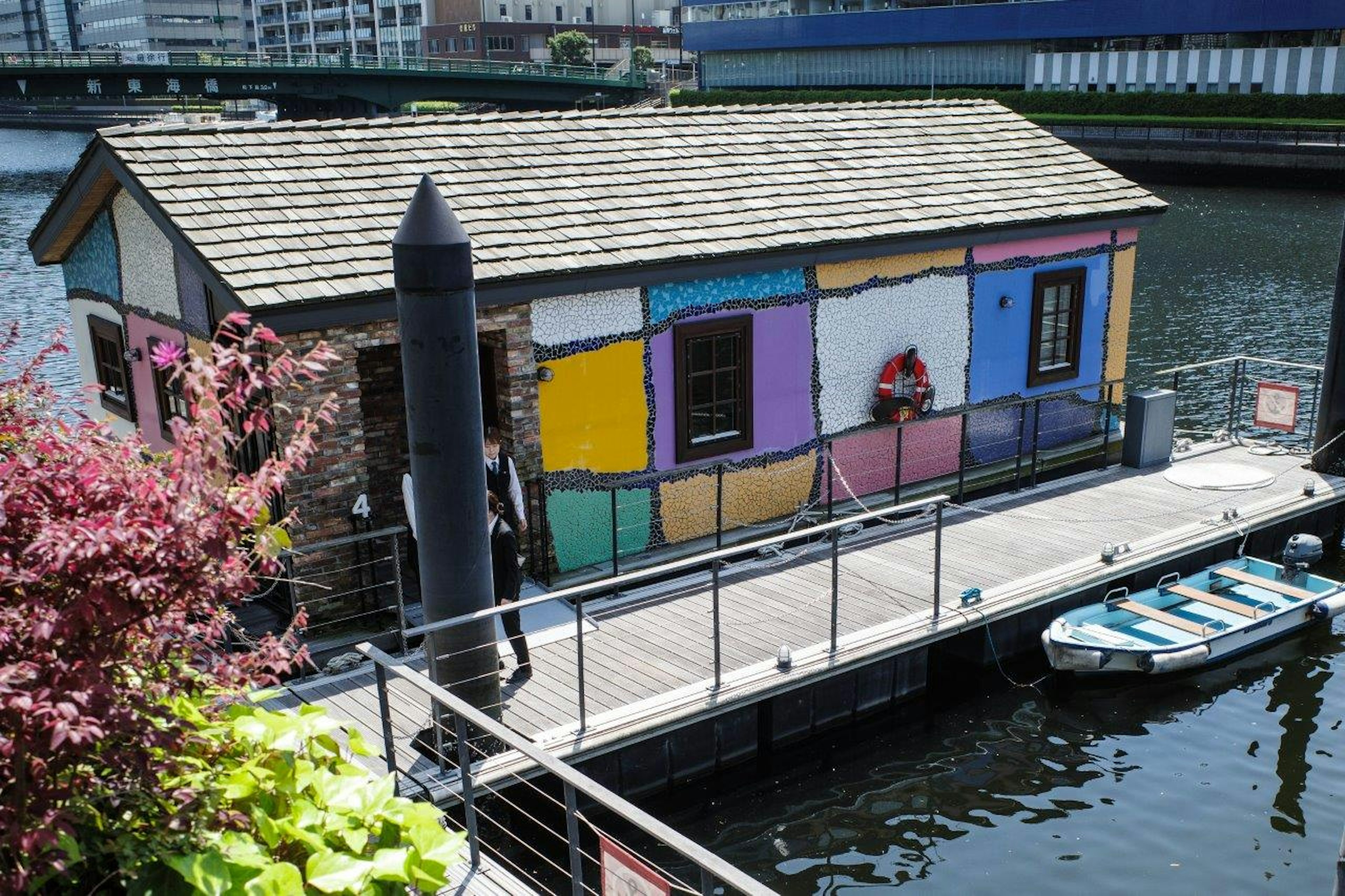 Colorful houseboat with vibrant walls and nearby dock