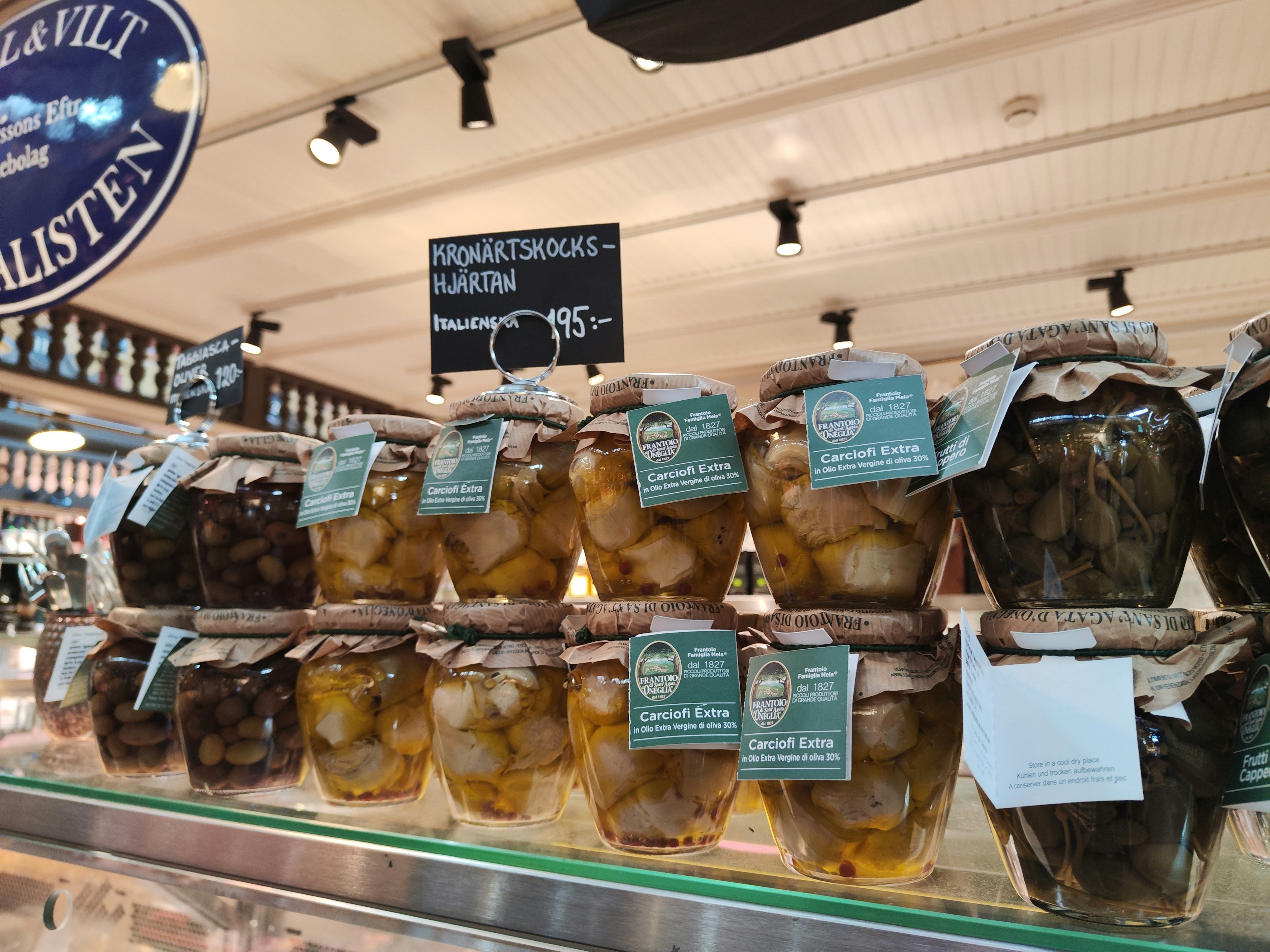 Jars of pickles arranged on display in a market