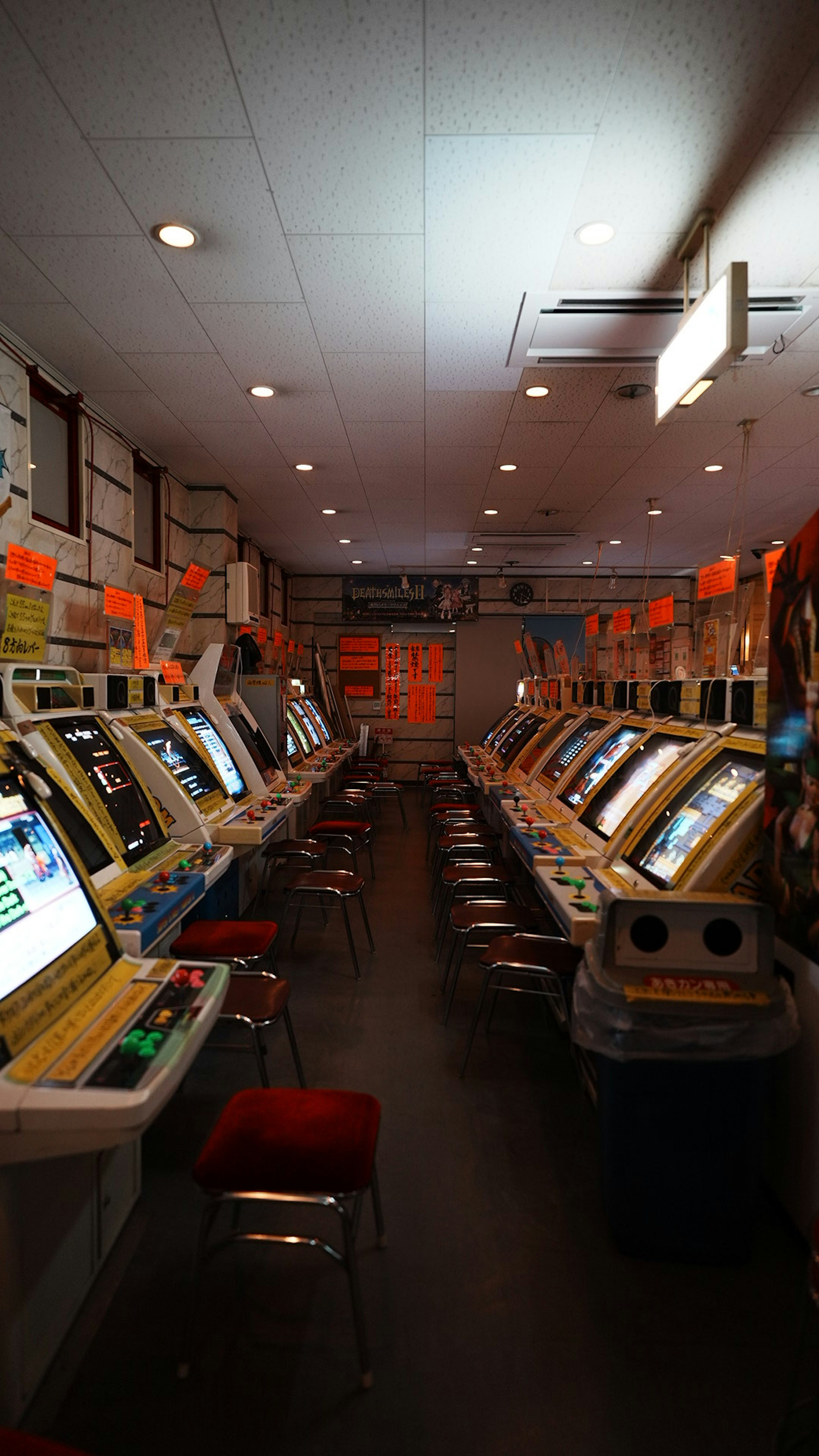 Interno di una sala giochi con file di slot machine