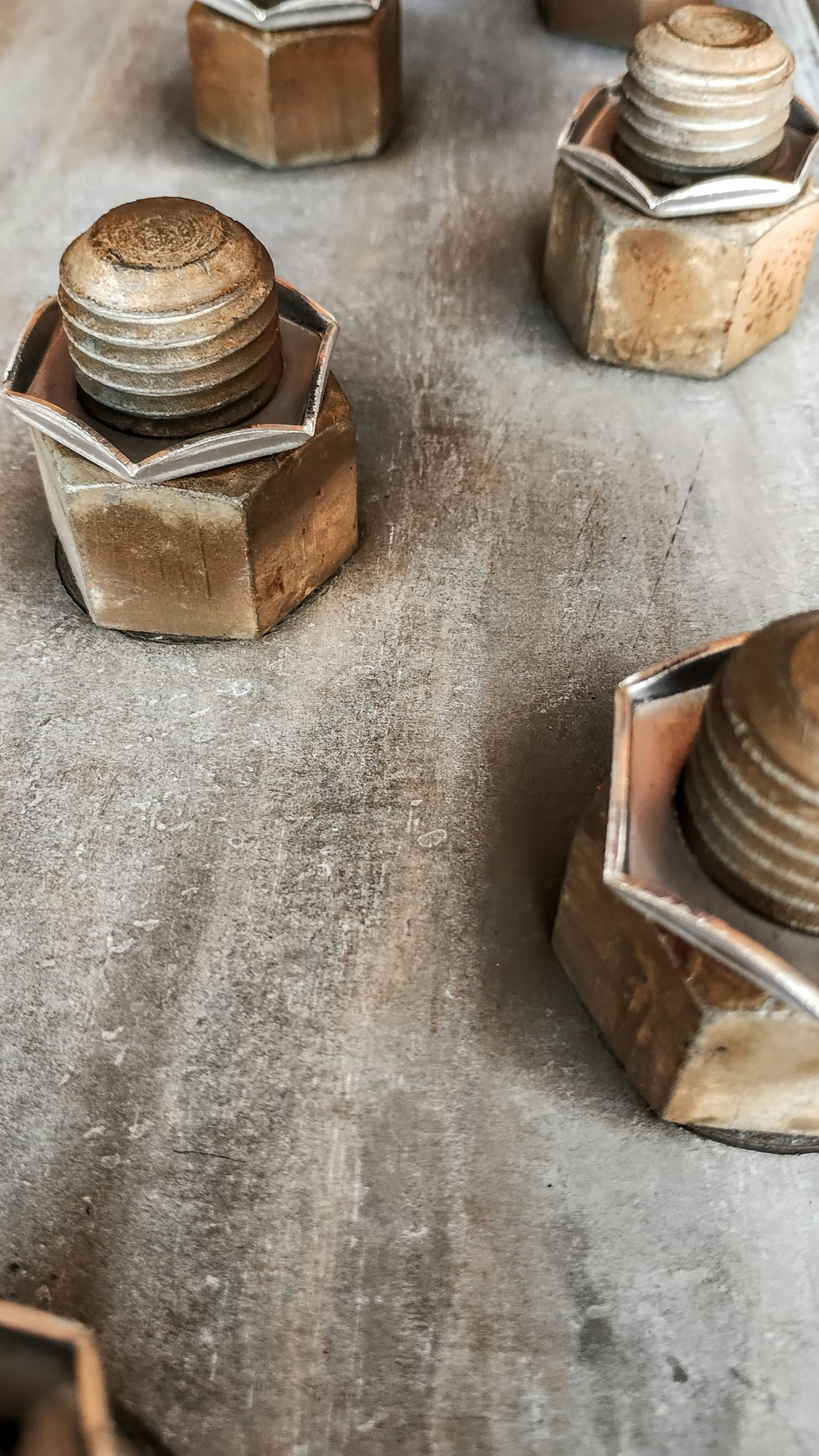 Close-up image of metal nuts arranged on a surface