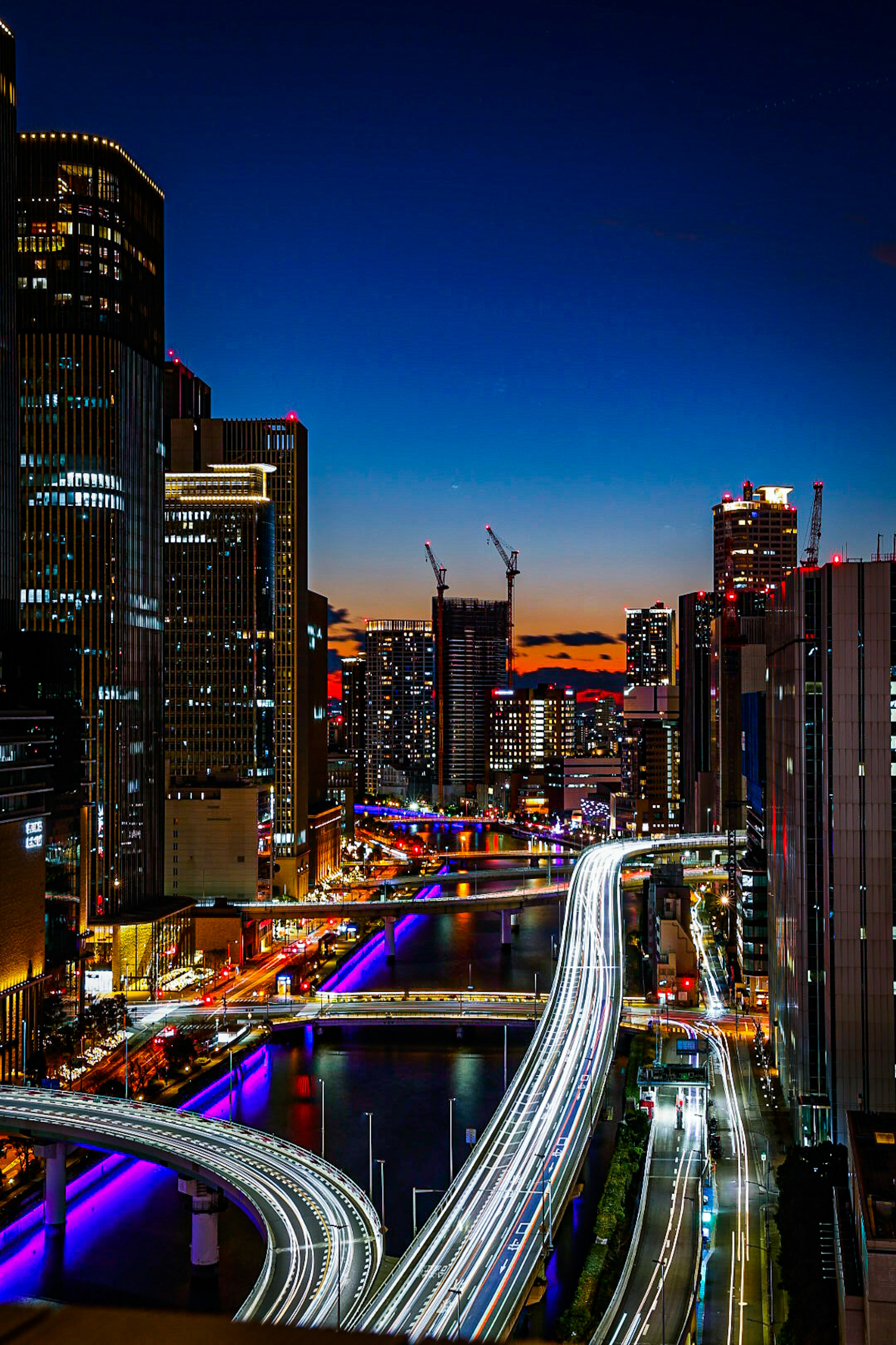 Paysage urbain nocturne avec des gratte-ciels et des traînées lumineuses